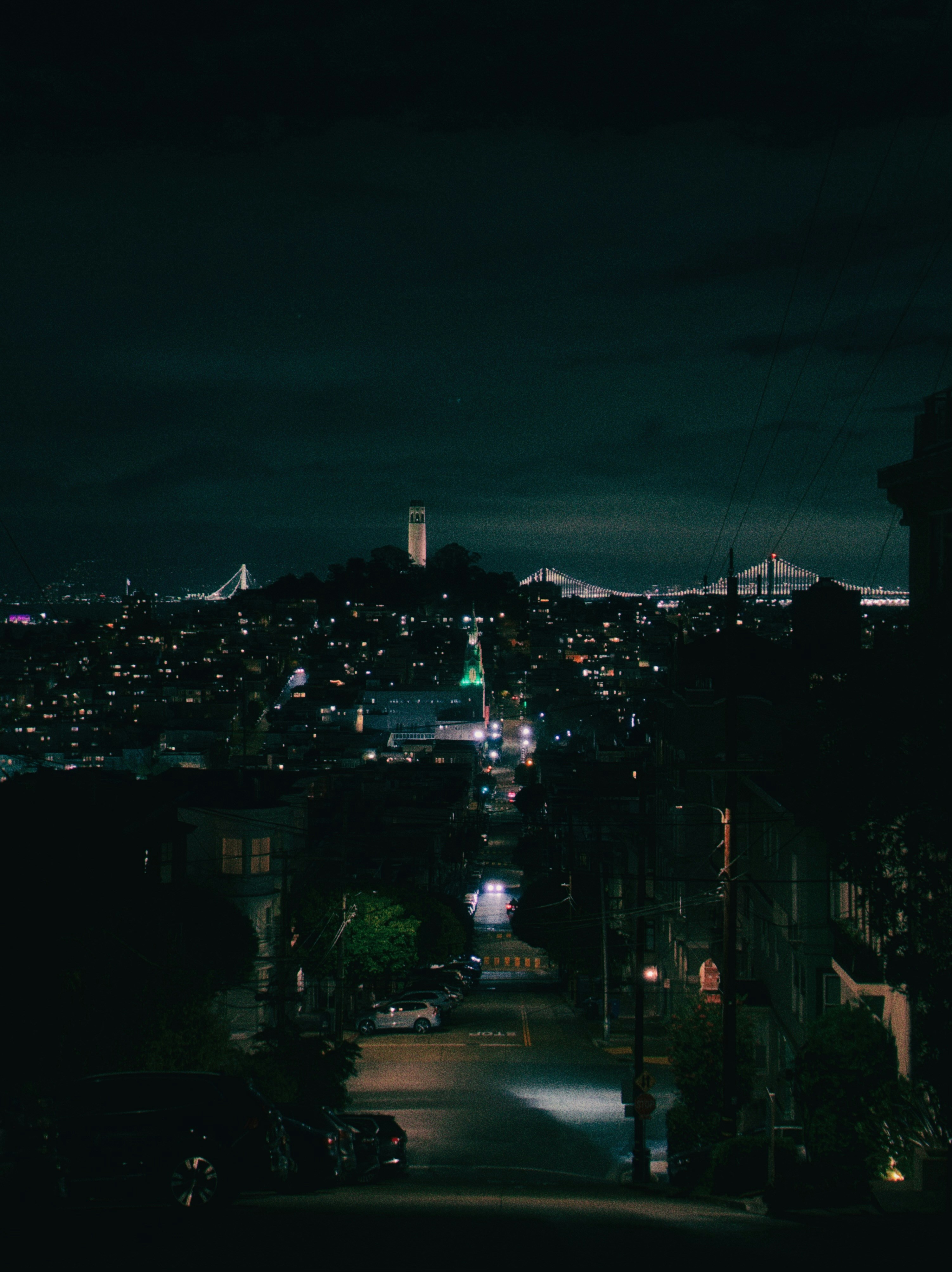 Coit Tower and Bay Bridge night - Free Photo on Unsplash