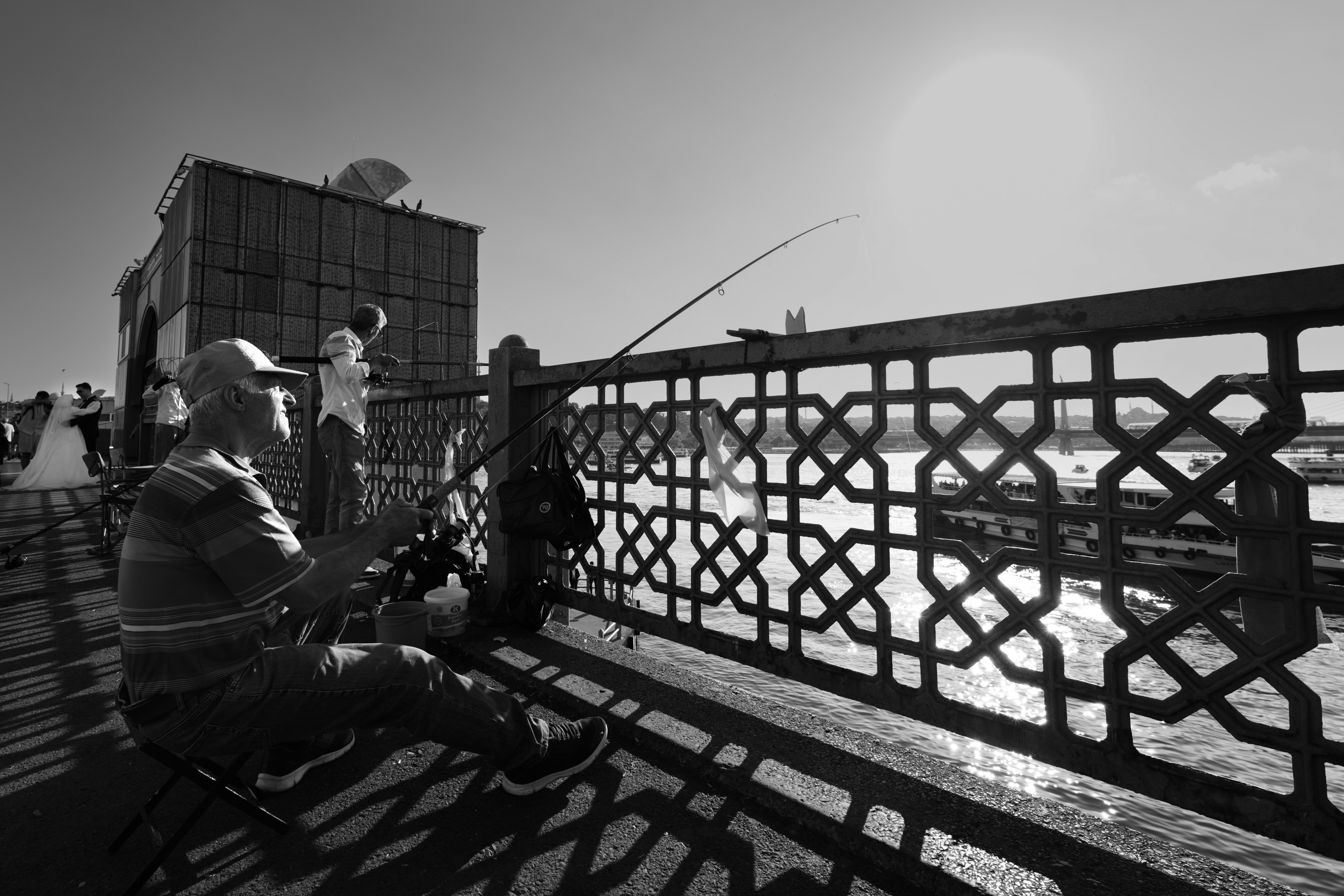 Person fishing from bridge with railing - Free Photo on Unsplash