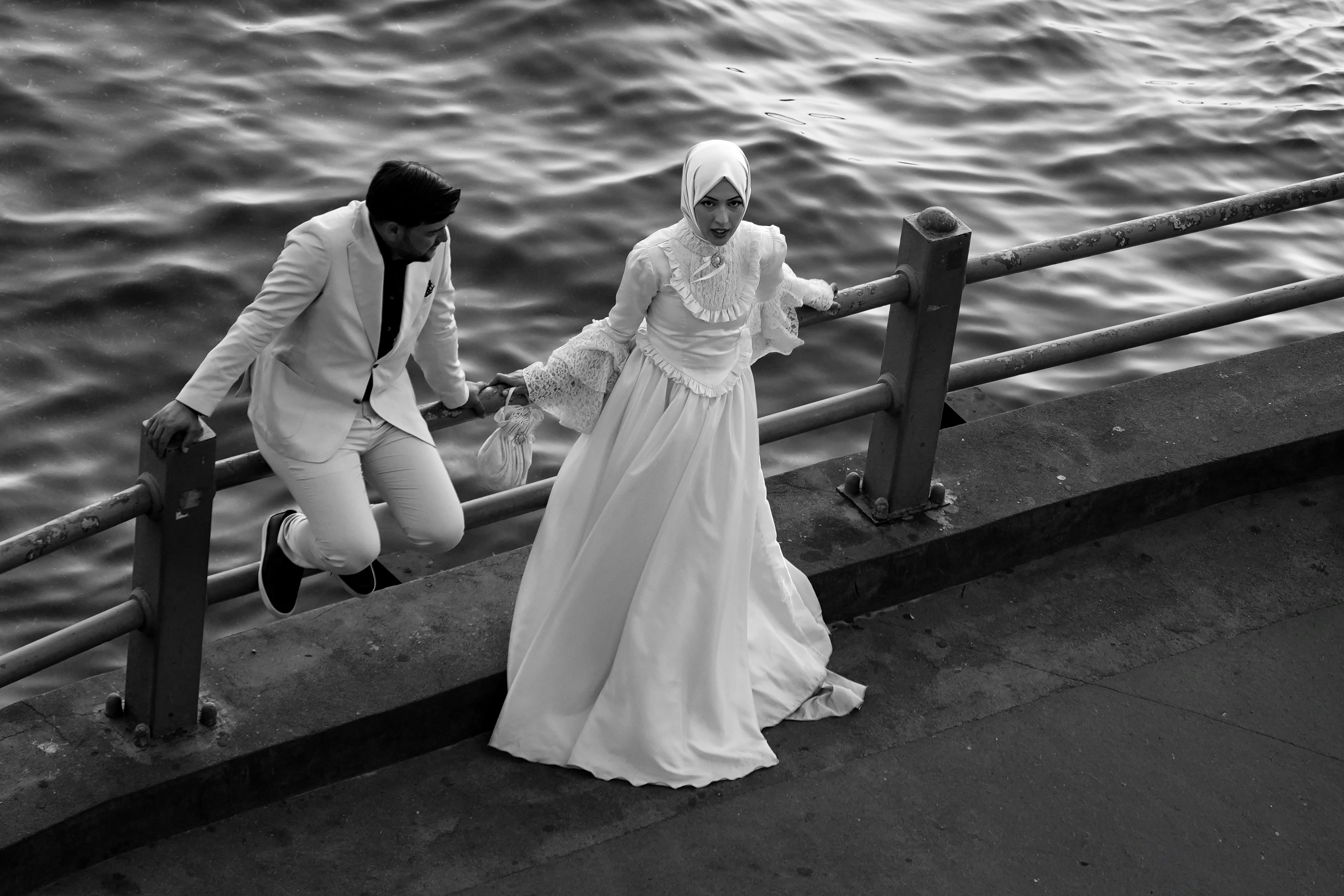 Wedding couple by waterfront railing - Free Photo on Unsplash