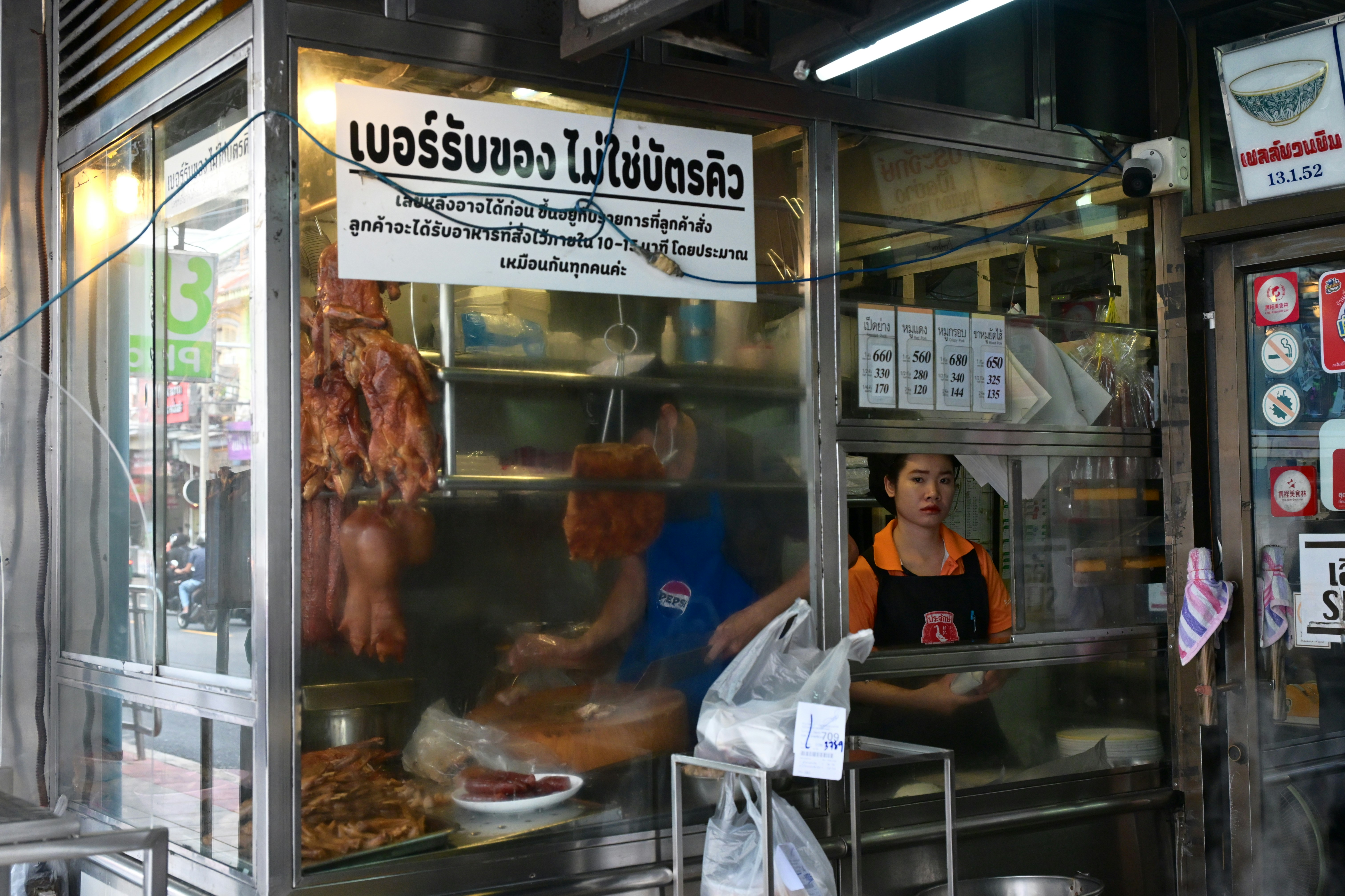 Woman working in glass food stall - Free Photo on Unsplash
