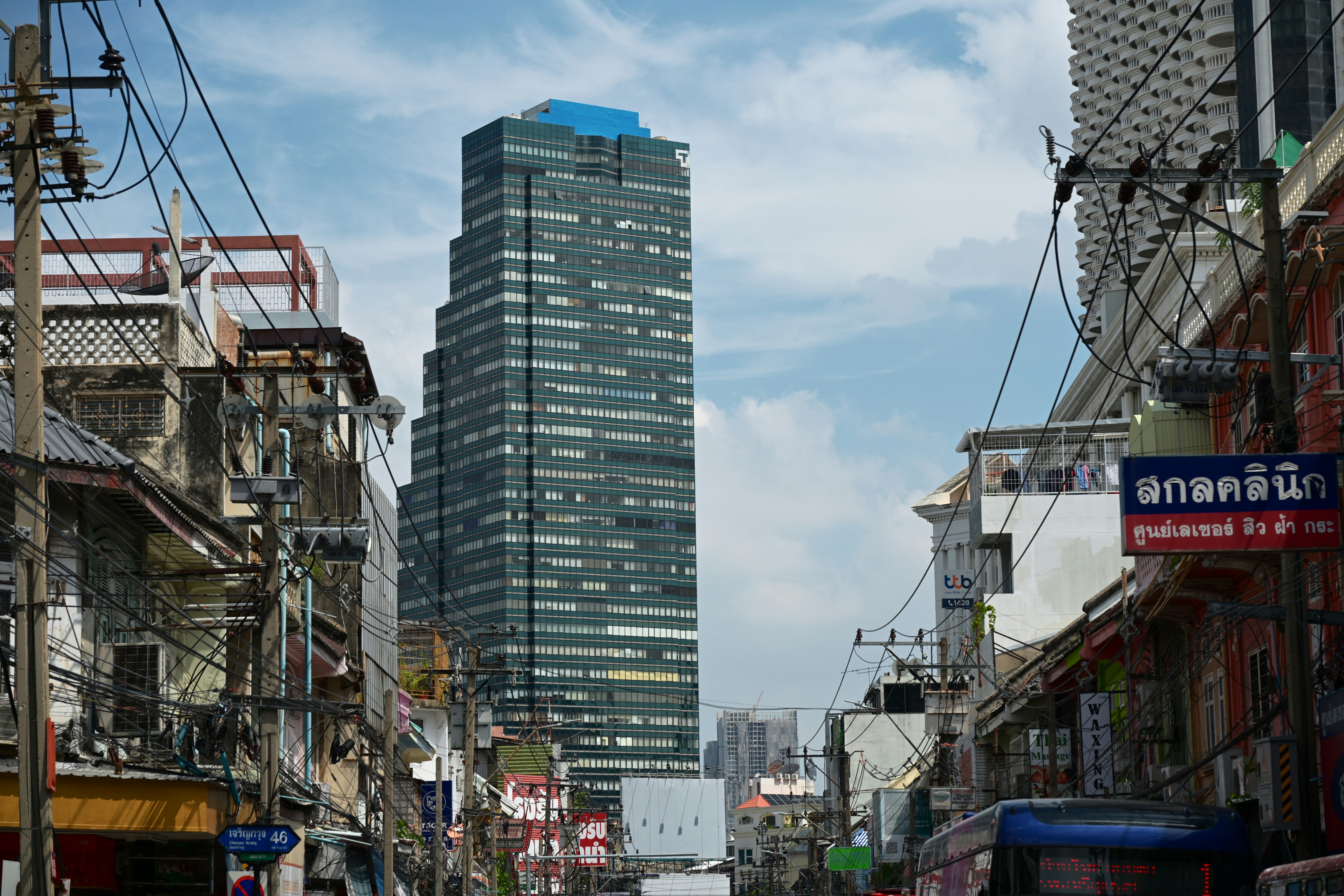 Skyscraper above dense Bangkok street - Free Photo on Unsplash