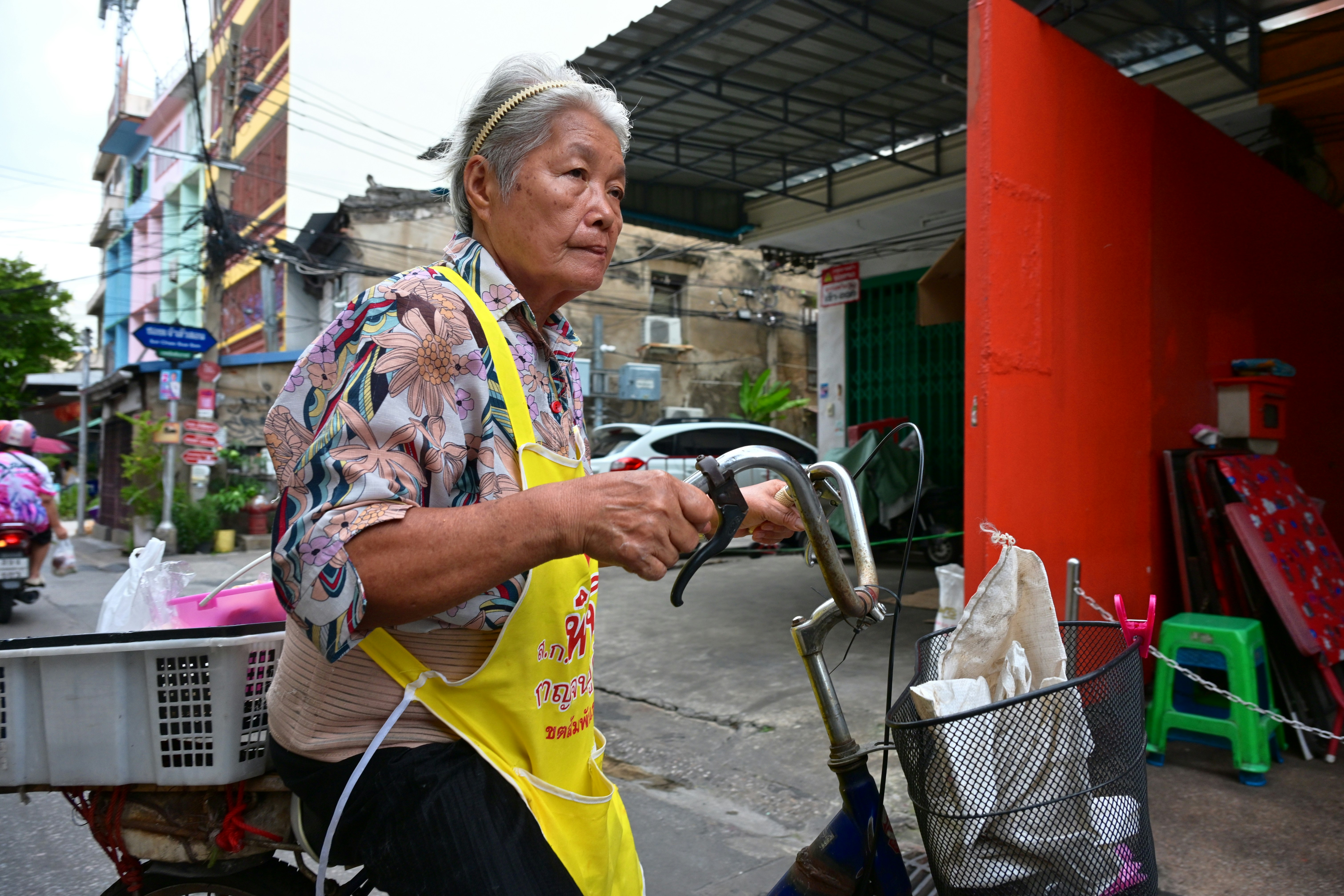Elderly woman riding bicycle on street - Free Photo on Unsplash