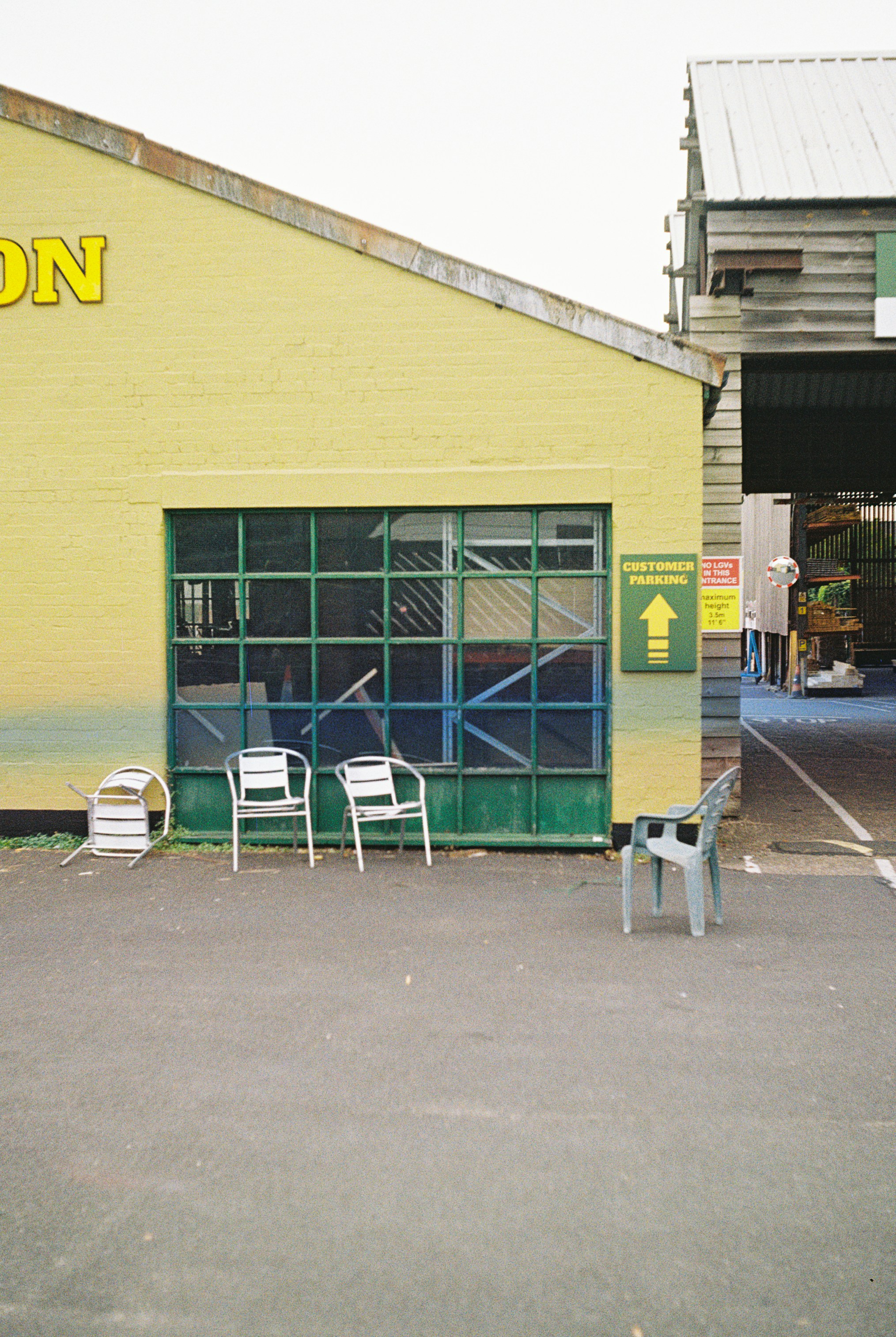Plastic chairs outside yellow building - Free Photo on Unsplash