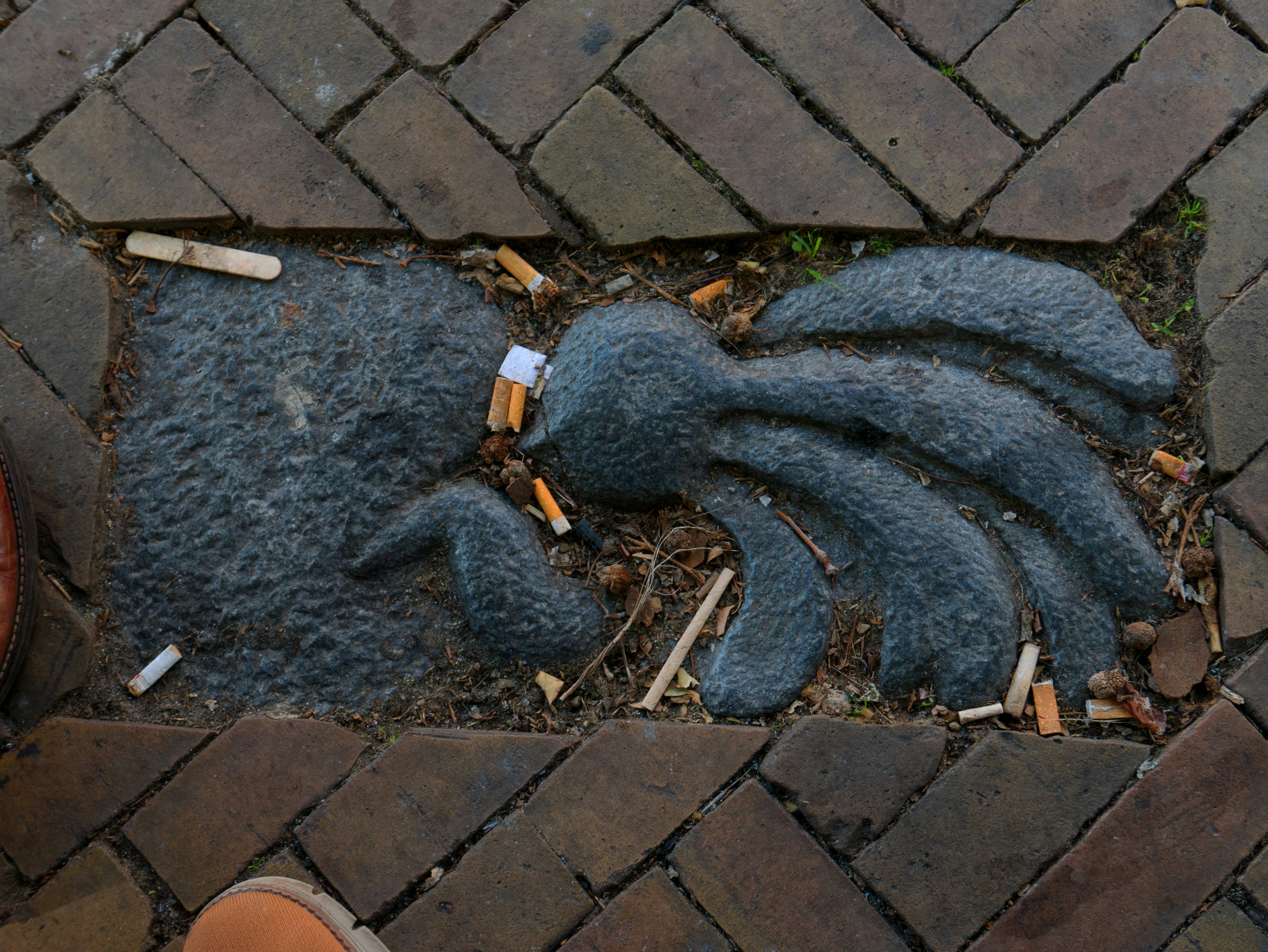 Stone octopus sculpture in brick pavement - Free Photo on Unsplash