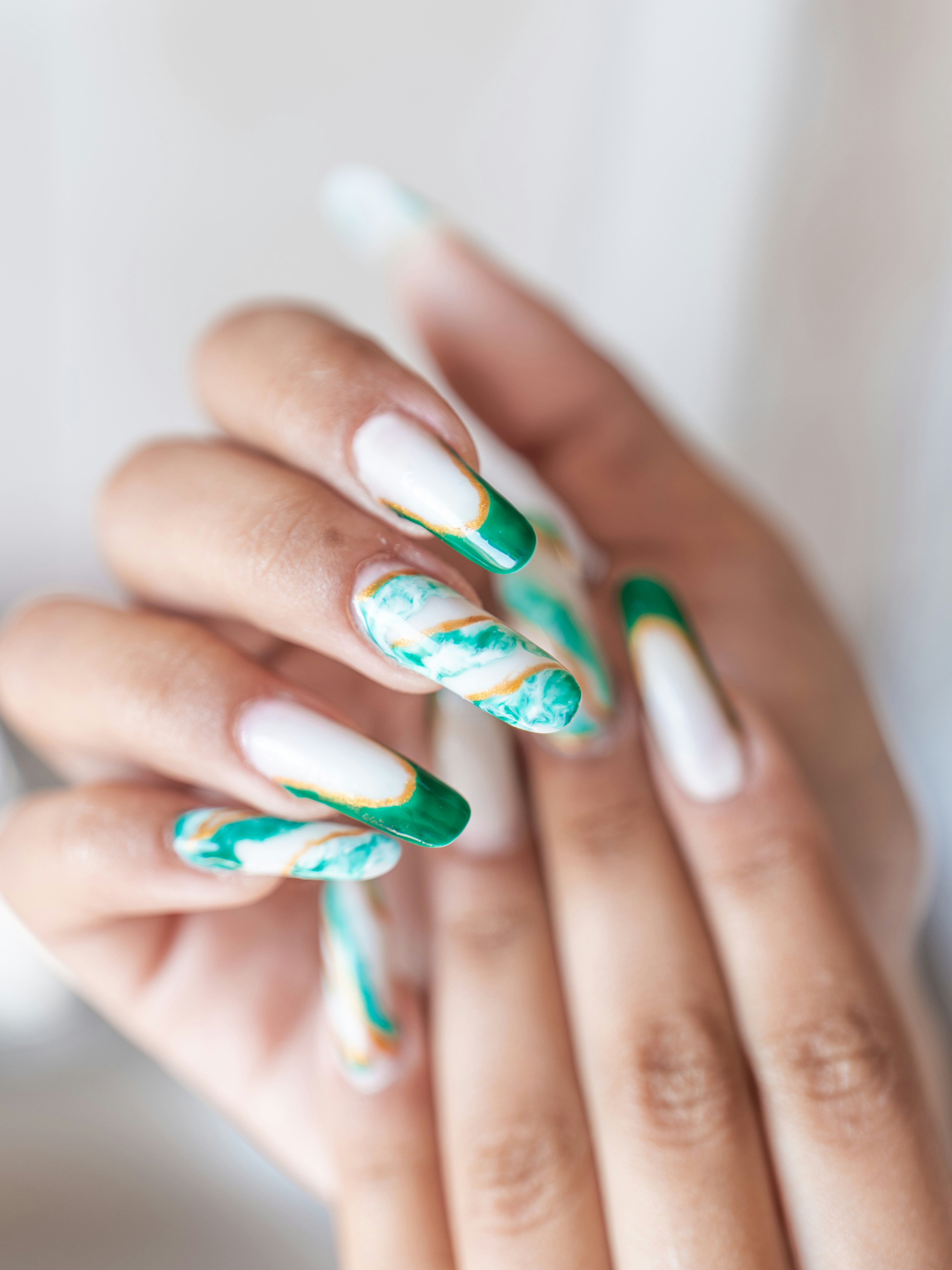 Long almond nails with green and white marble swirls