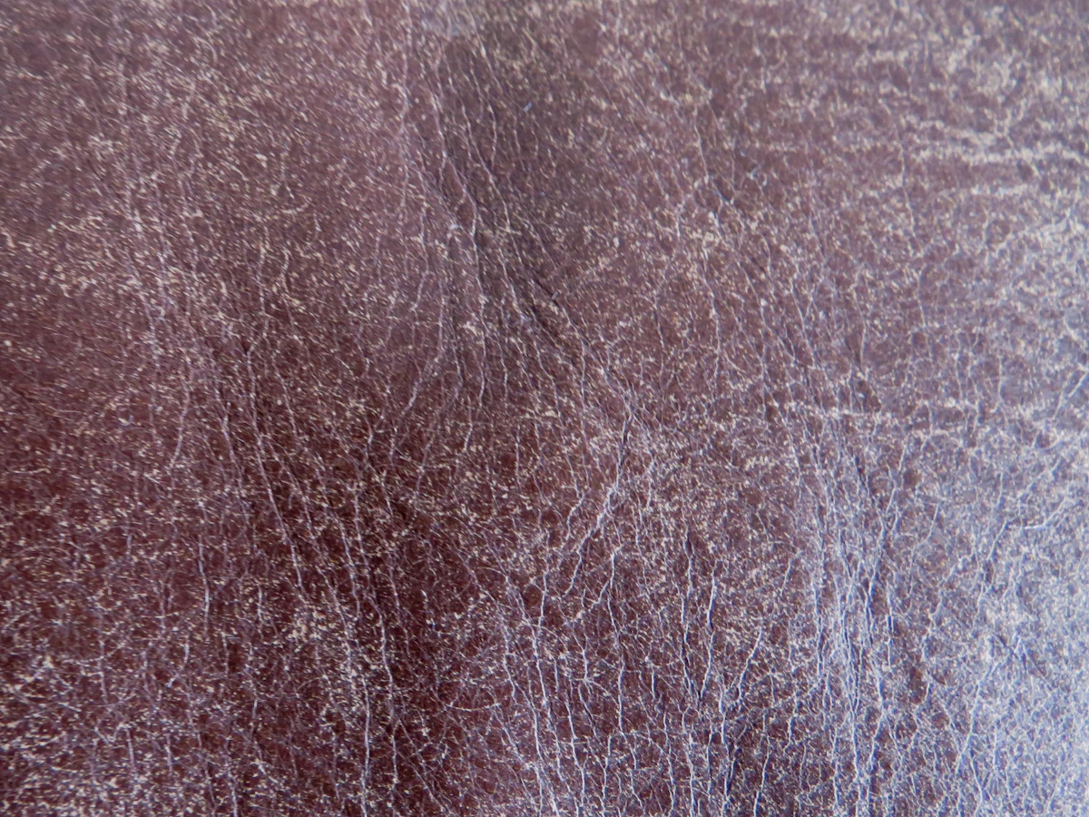Oxblood leather with creases and worn grain