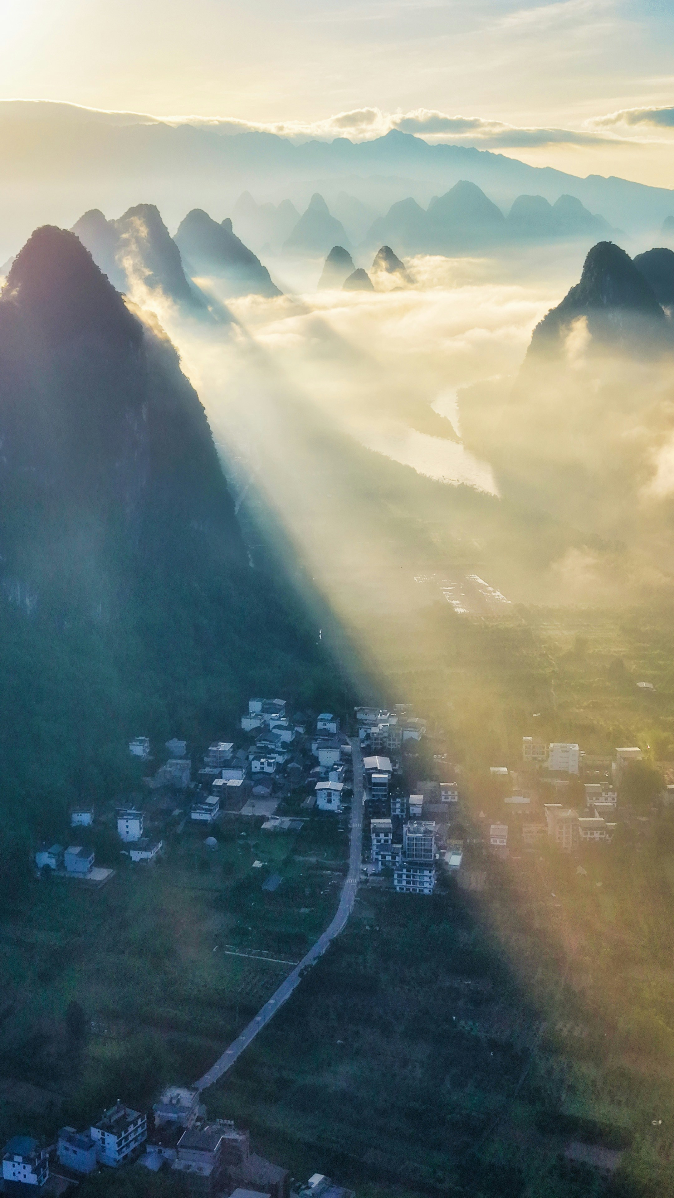 Village among karst mountains in mist - Free Photo on Unsplash