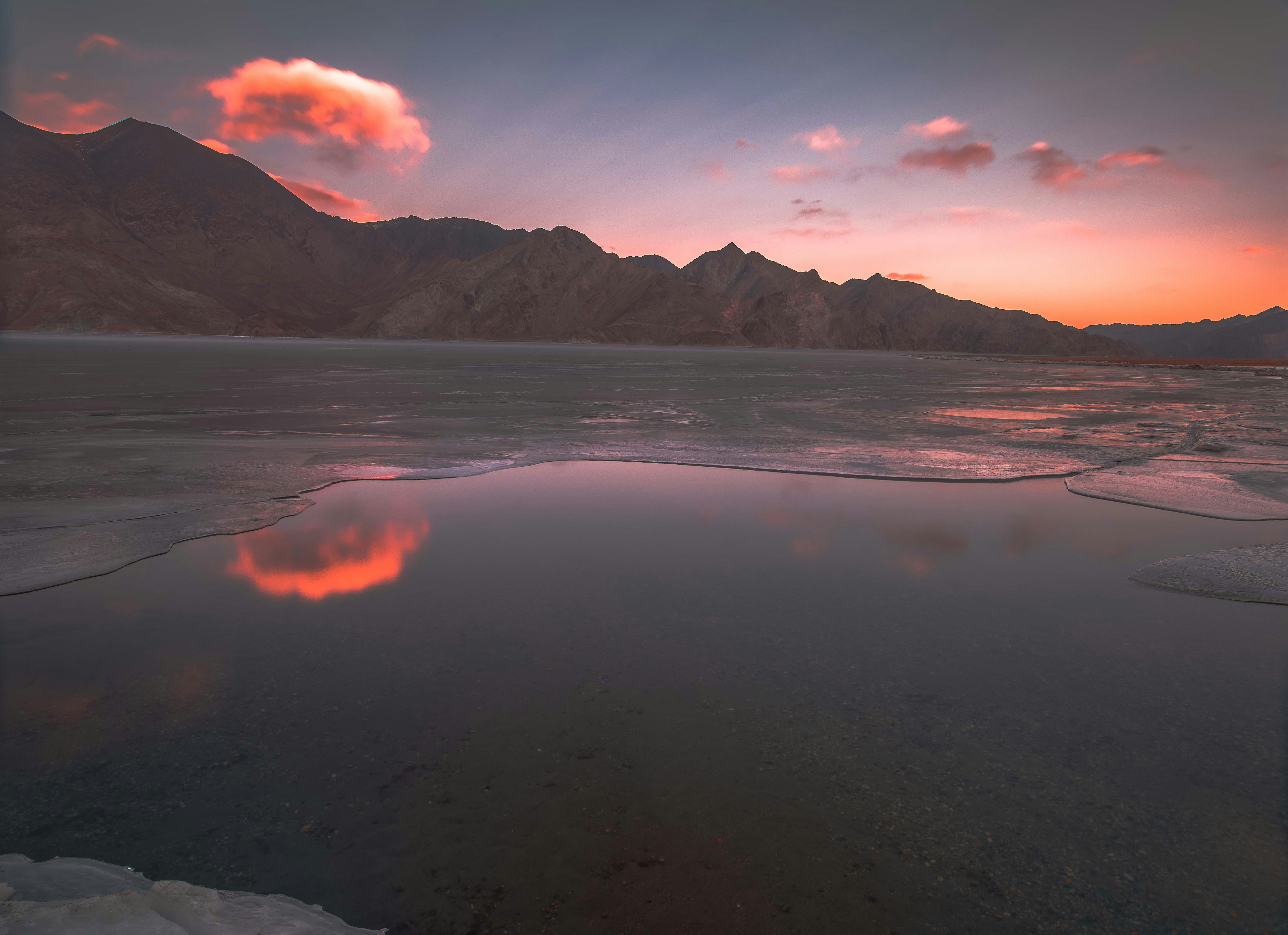 Frozen lake under warm mountain sky - Free Photo on Unsplash