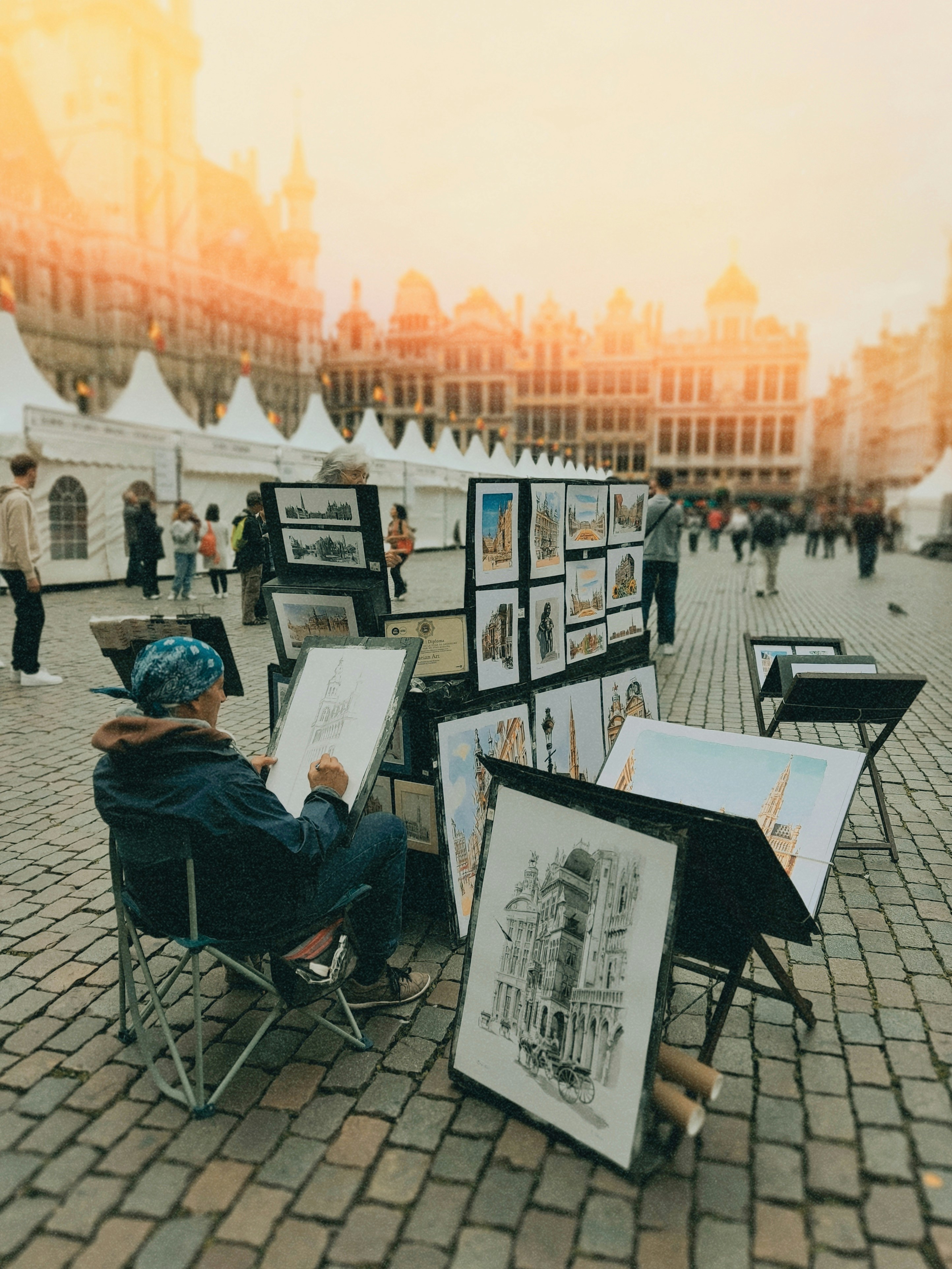 Artist sketching on Brussels cobblestone square - Free Photo on Unsplash