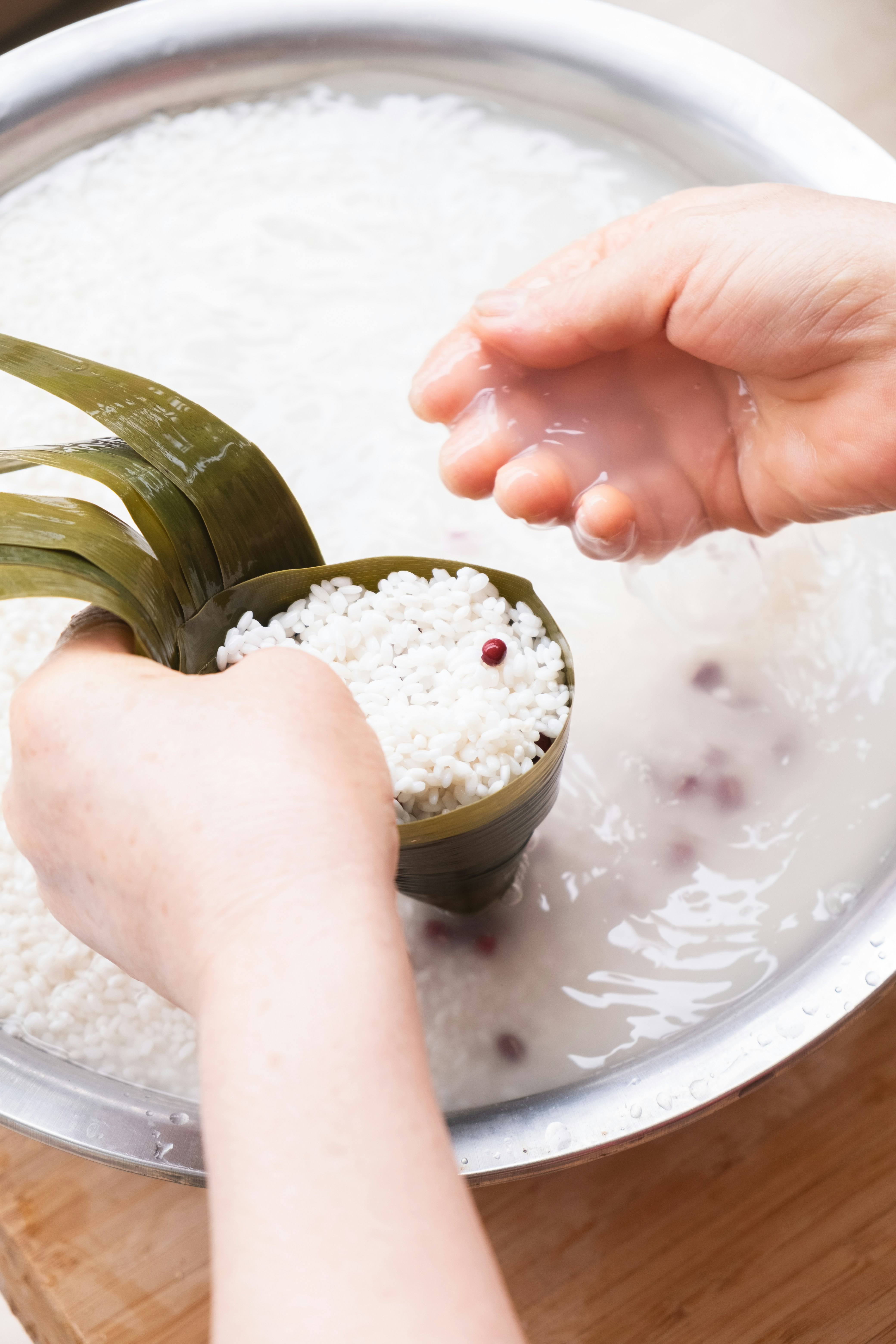Hands filling bamboo leaf with rice - Free Photo on Unsplash