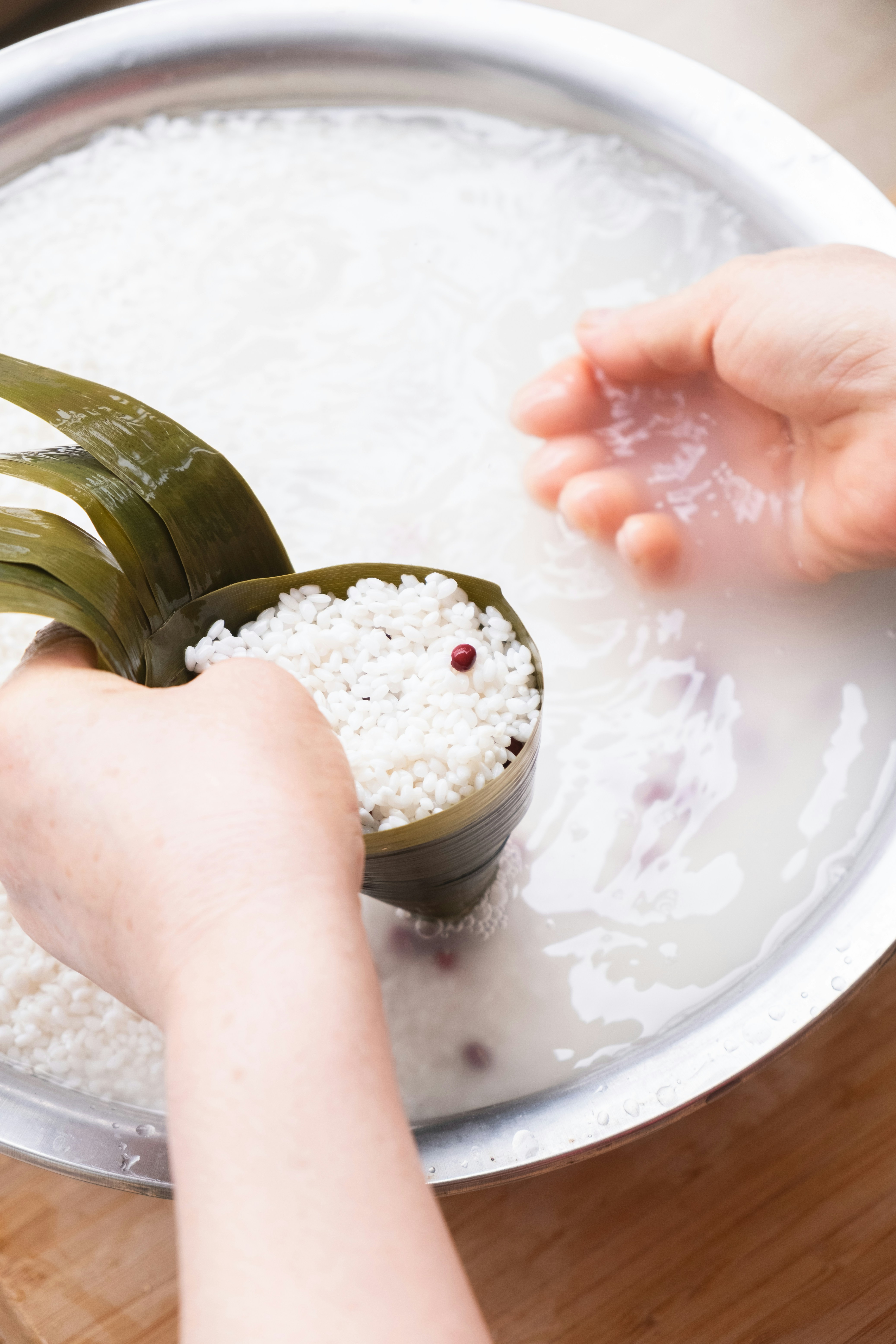 Hands filling bamboo leaf with rice - Free Photo on Unsplash
