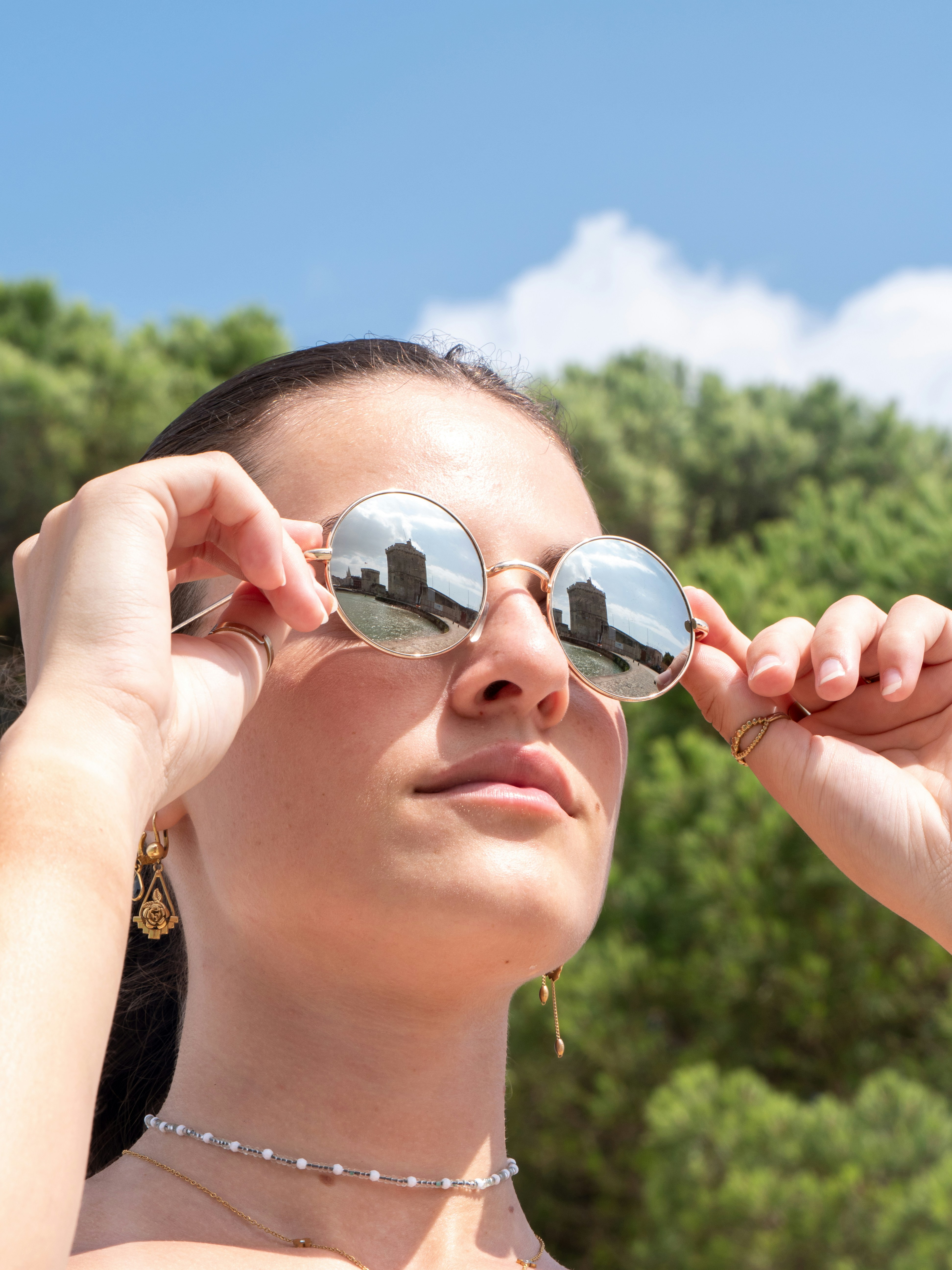 Woman wearing sunglasses reflecting Belem Tower - Free Photo on Unsplash