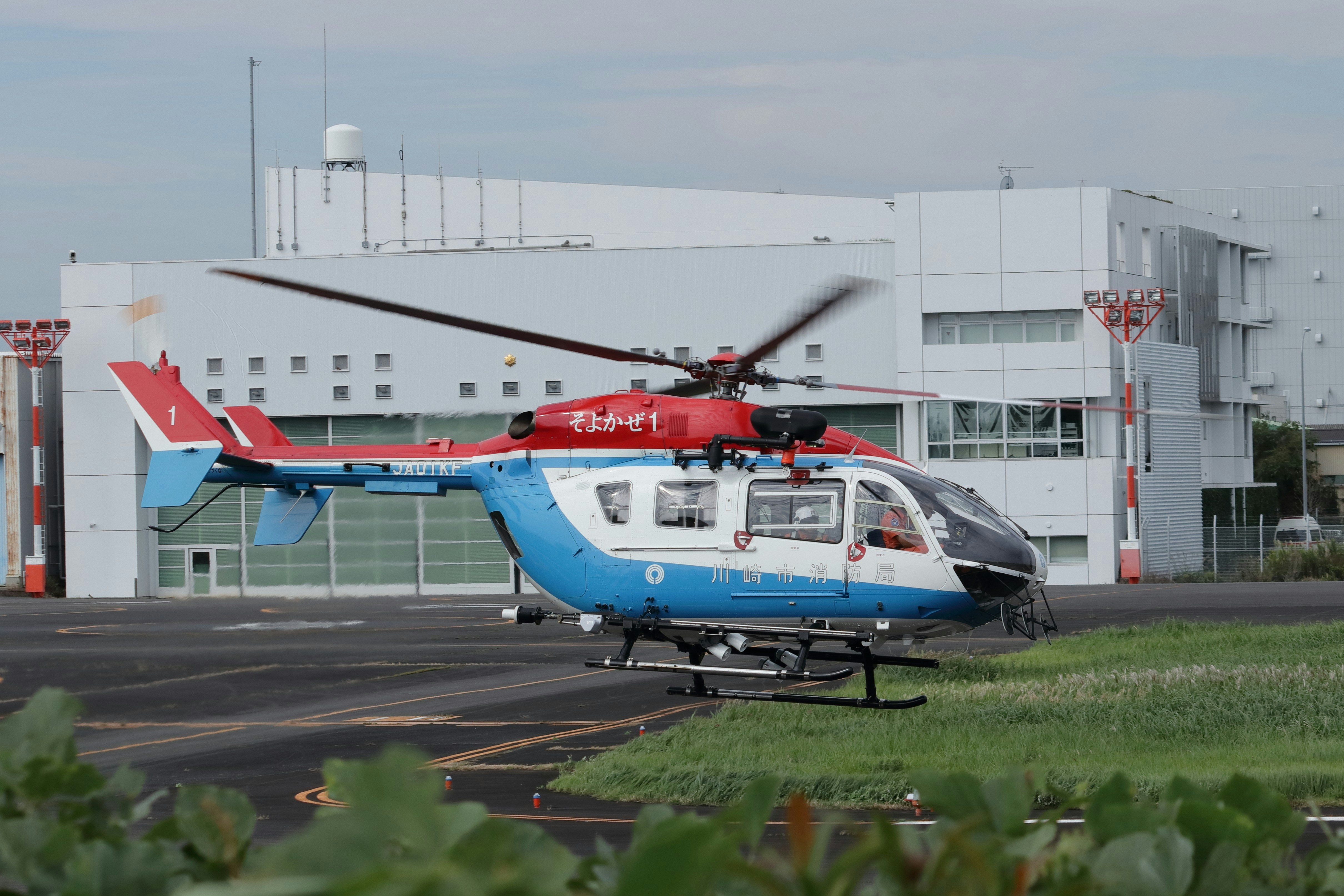 Rescue helicopter hovering near hangar - Free Photo on Unsplash