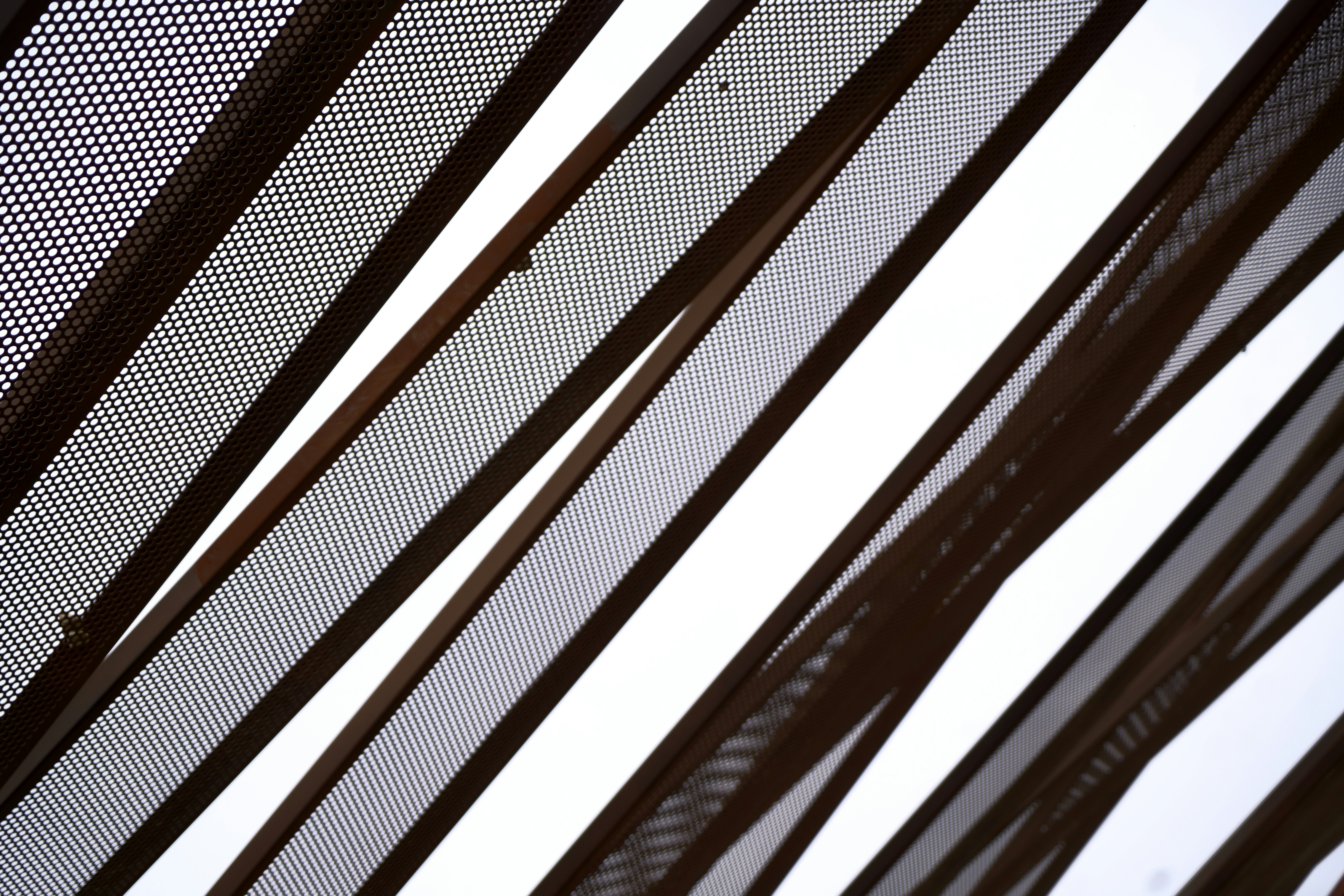 Diagonal perforated metal slats against sky - Free Photo on Unsplash