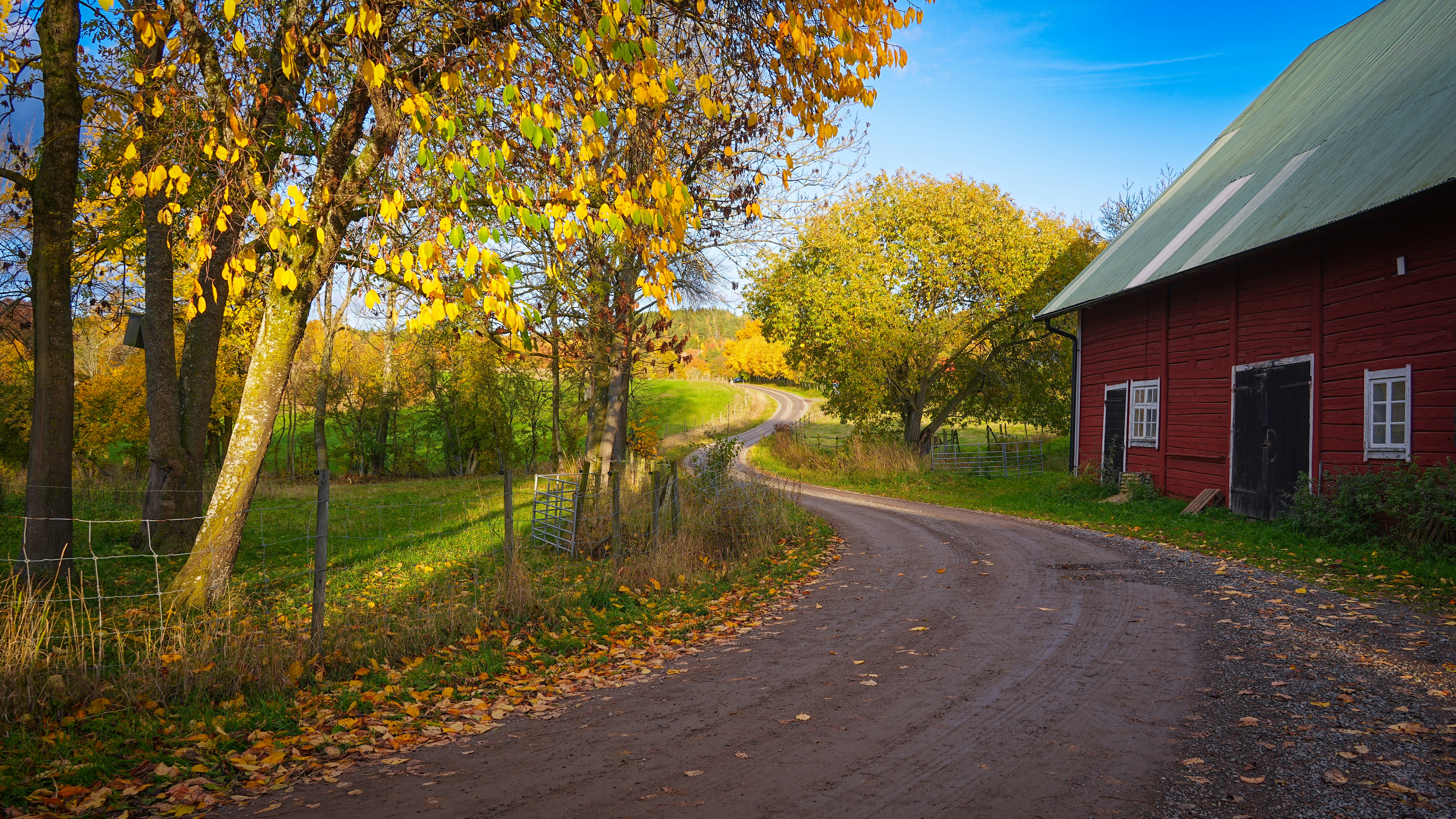 Winding dirt road by red barn - Free Photo on Unsplash