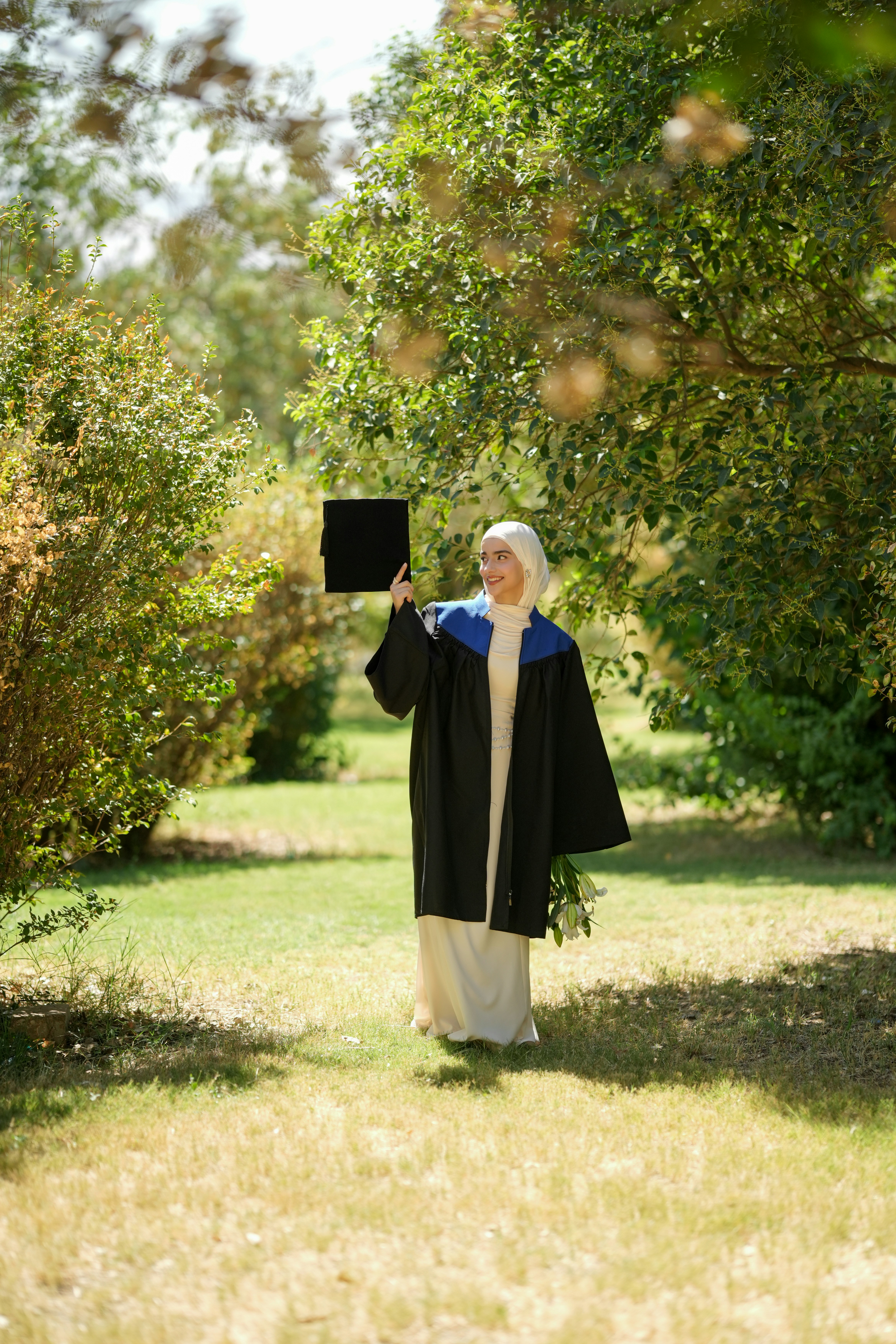 Woman in graduation gown in park - Free Photo on Unsplash