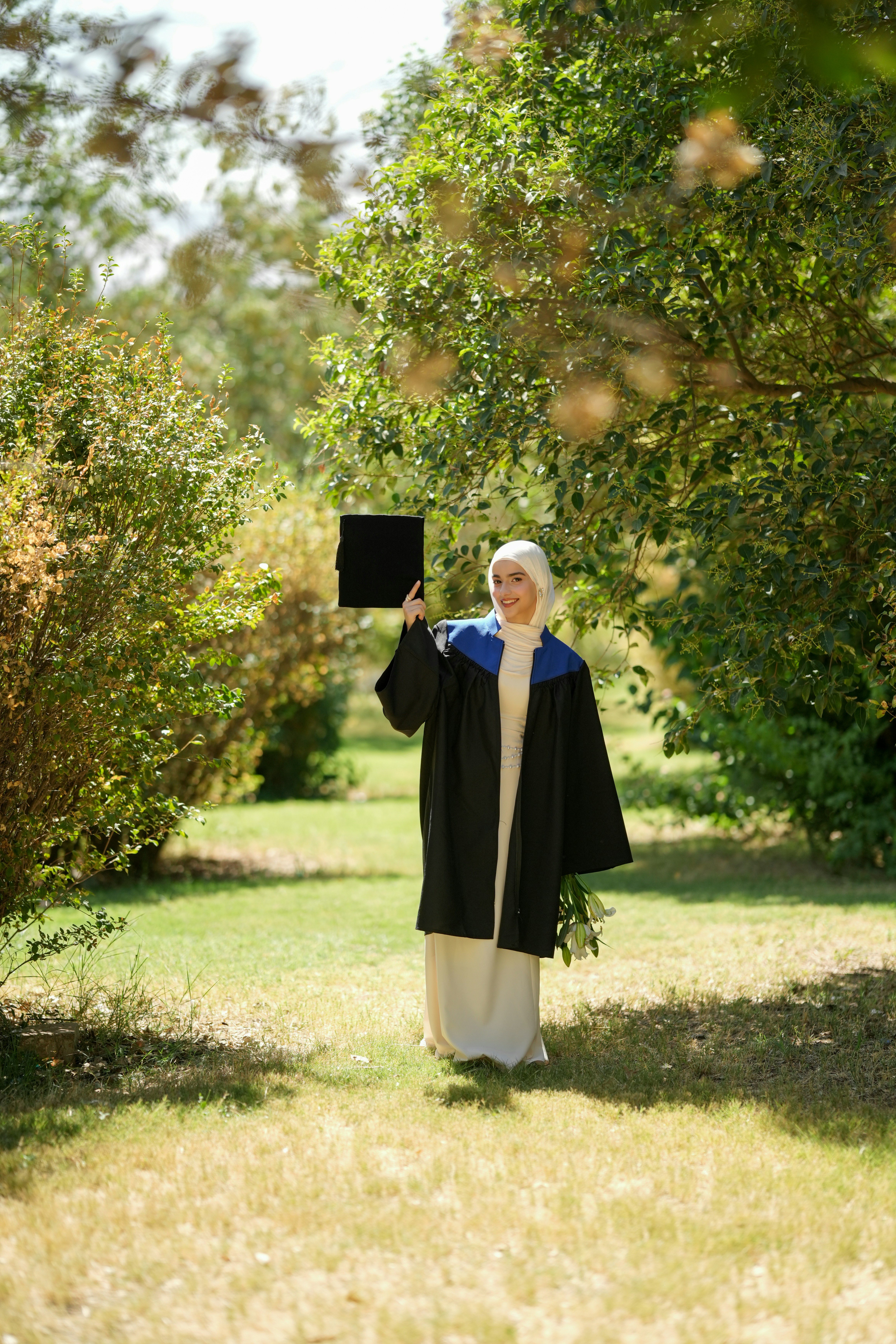 Woman in graduation gown in park - Free Photo on Unsplash