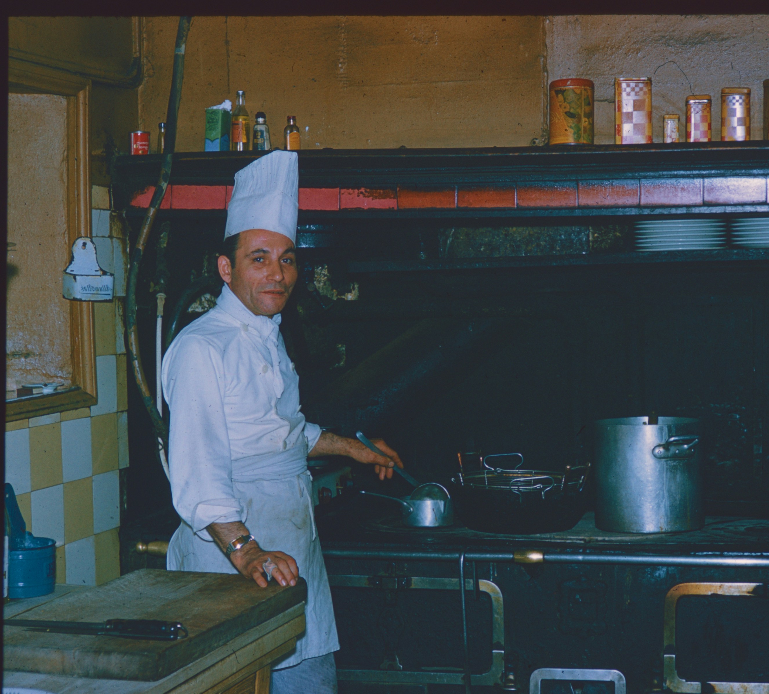A cleaner in a navy uniform wiping down a kitchen counter in an empty Dublin rental apartment