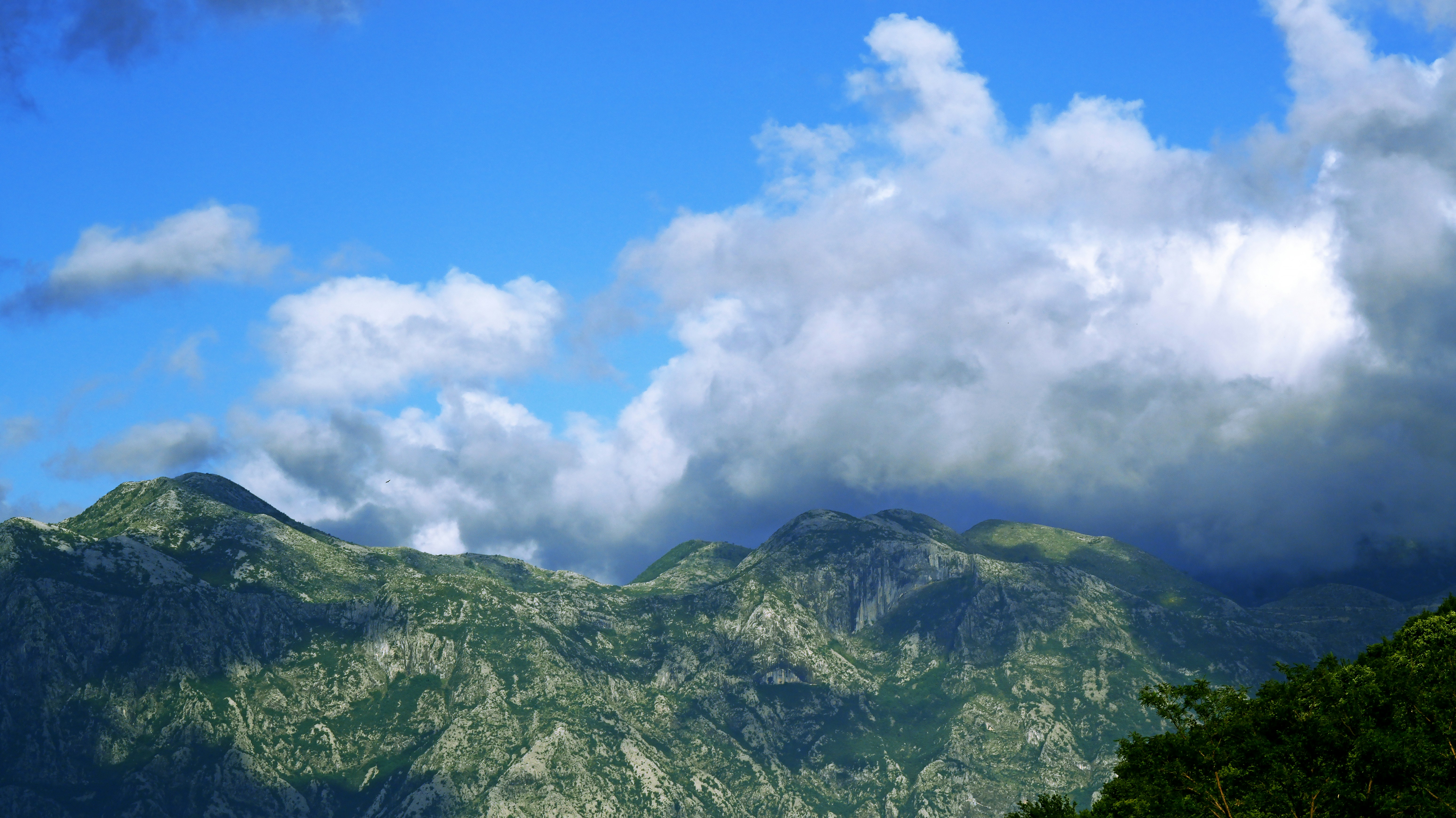 Rugged green mountains under blue sky - Free Photo on Unsplash