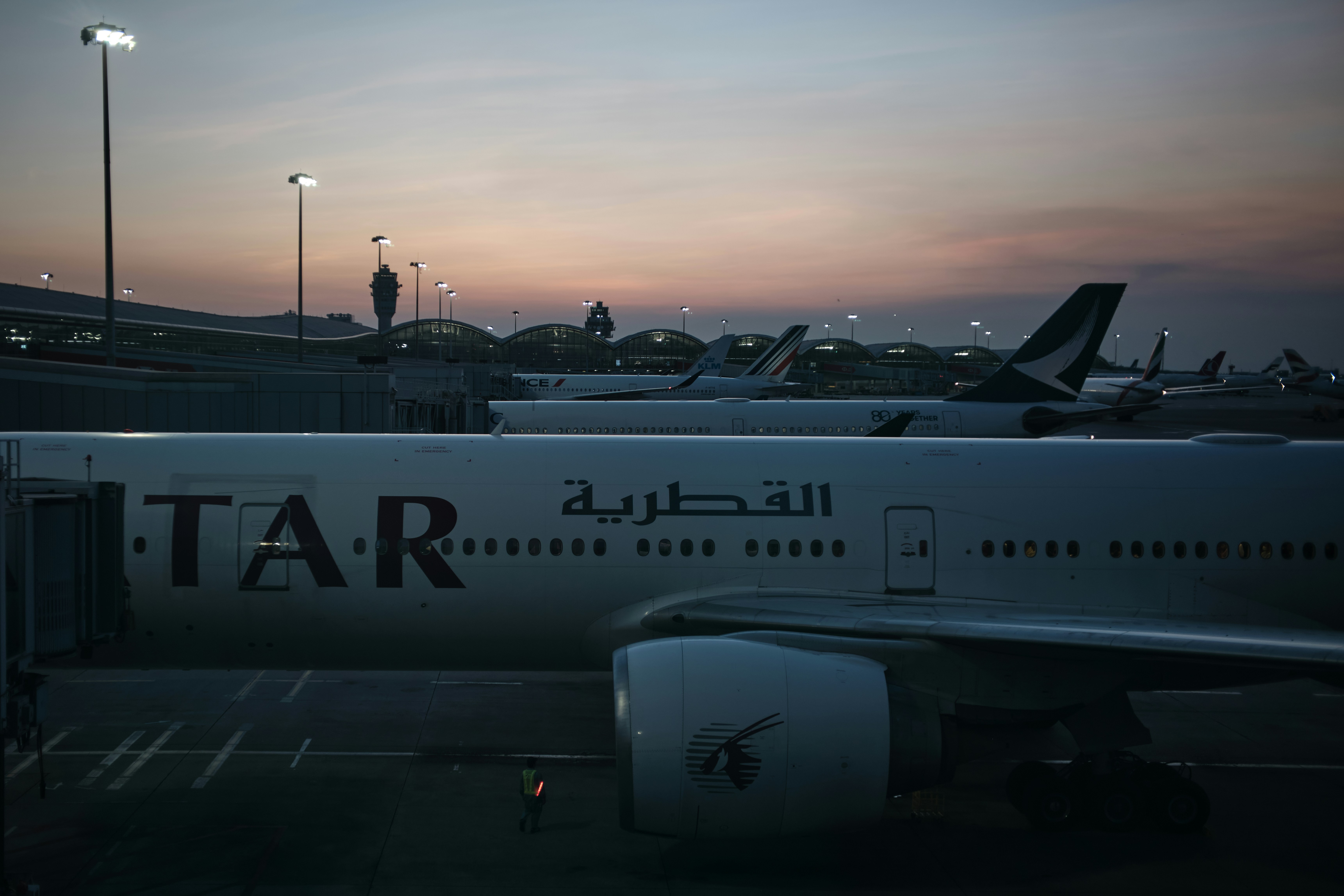 Qatar Airways plane at airport terminal - Free Photo on Unsplash