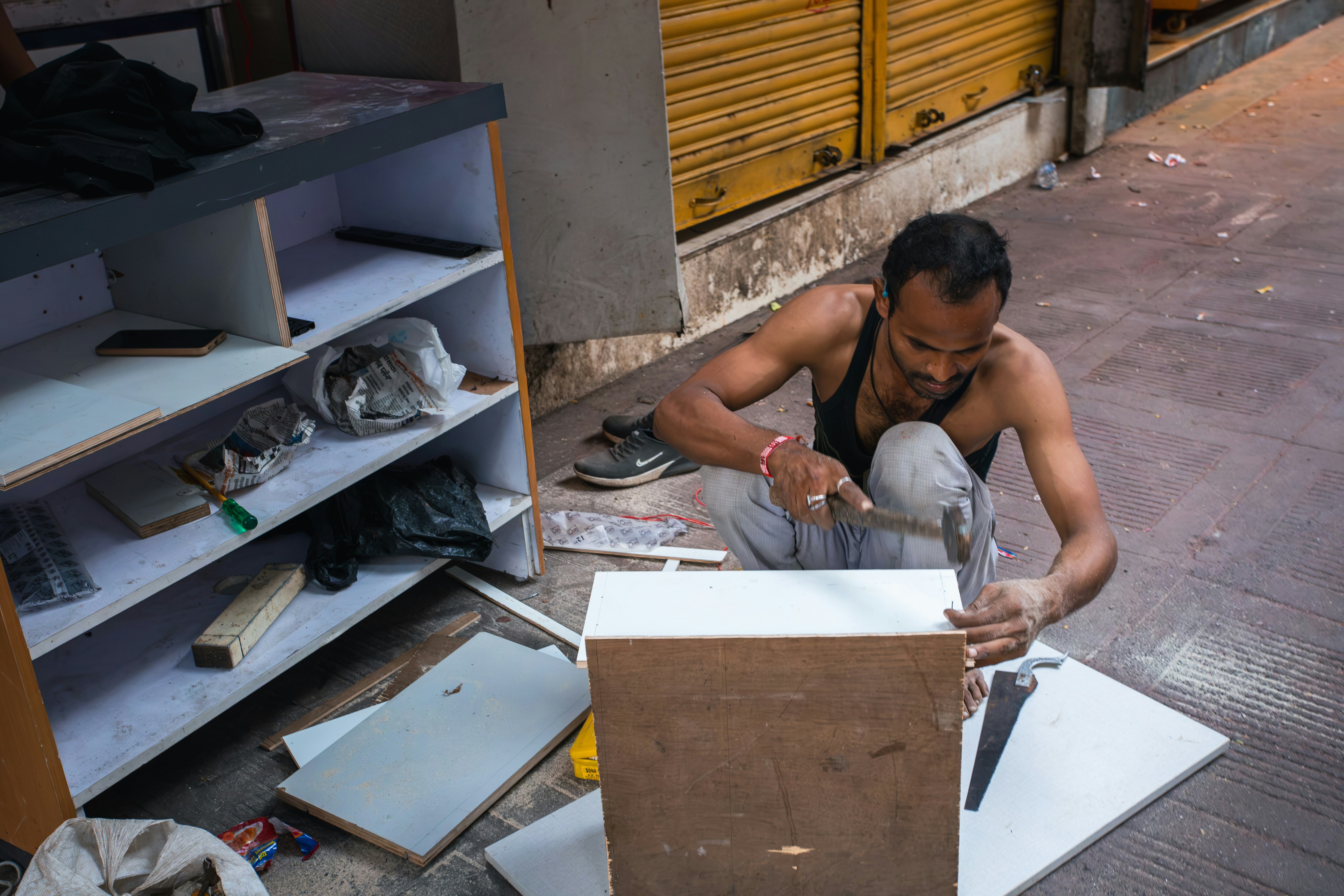 Man hammering wooden panel on sidewalk - Free Photo on Unsplash