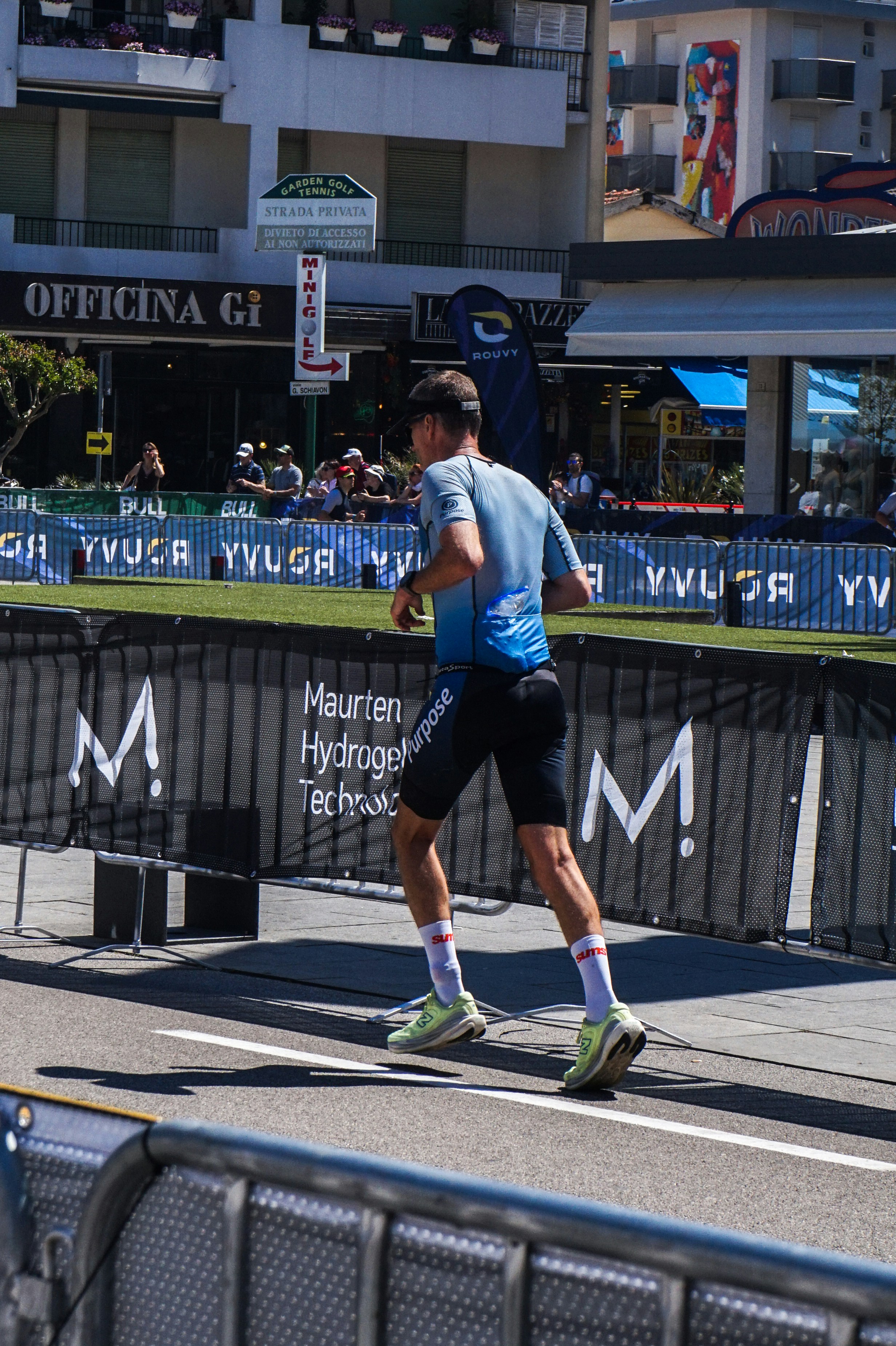 Triathlete running on sunny city street - Free Photo on Unsplash