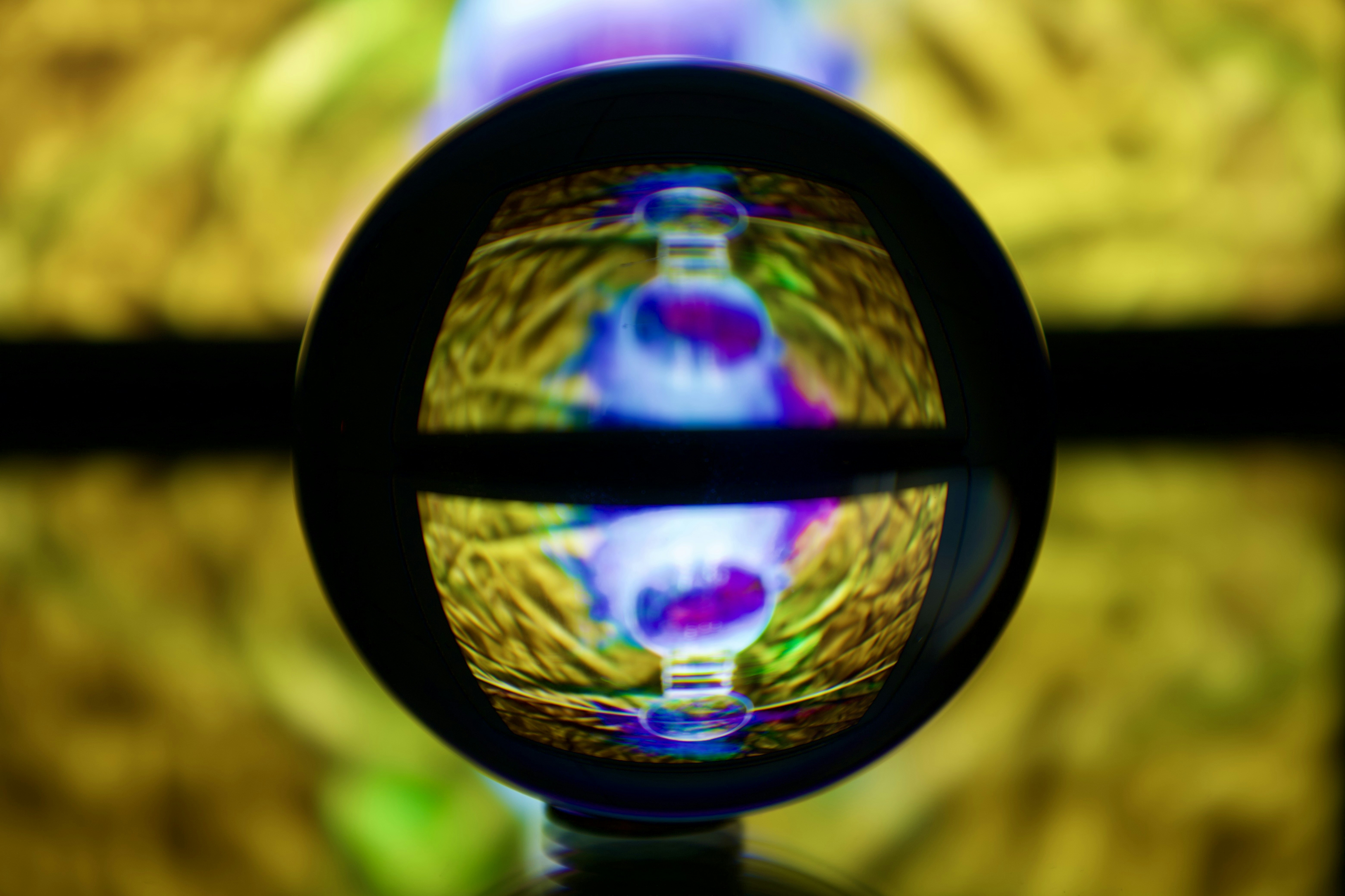 Glass sphere reflecting colorful light patterns - Free Photo on Unsplash