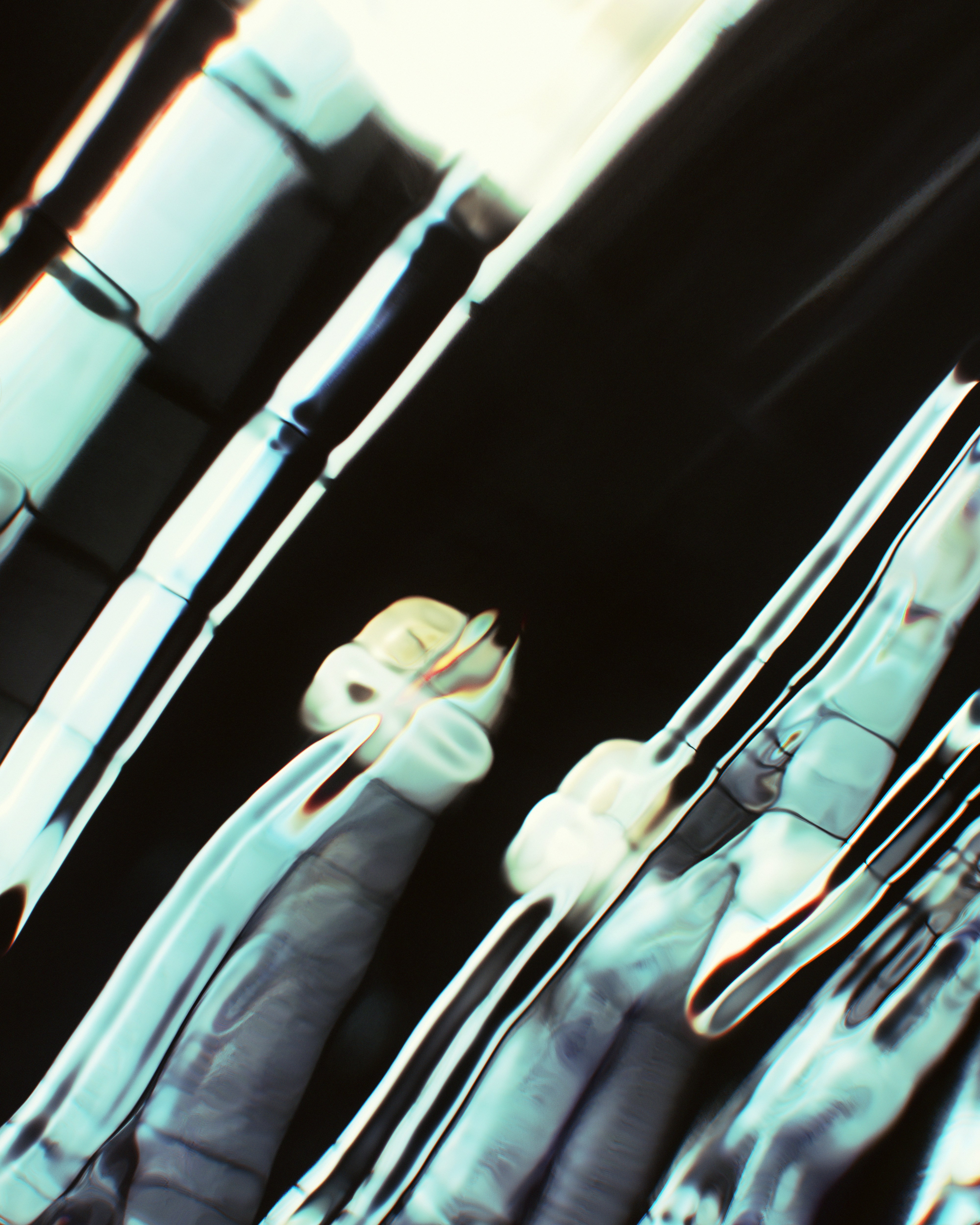 Abstract light reflections on a curved metallic surface with deep shadows