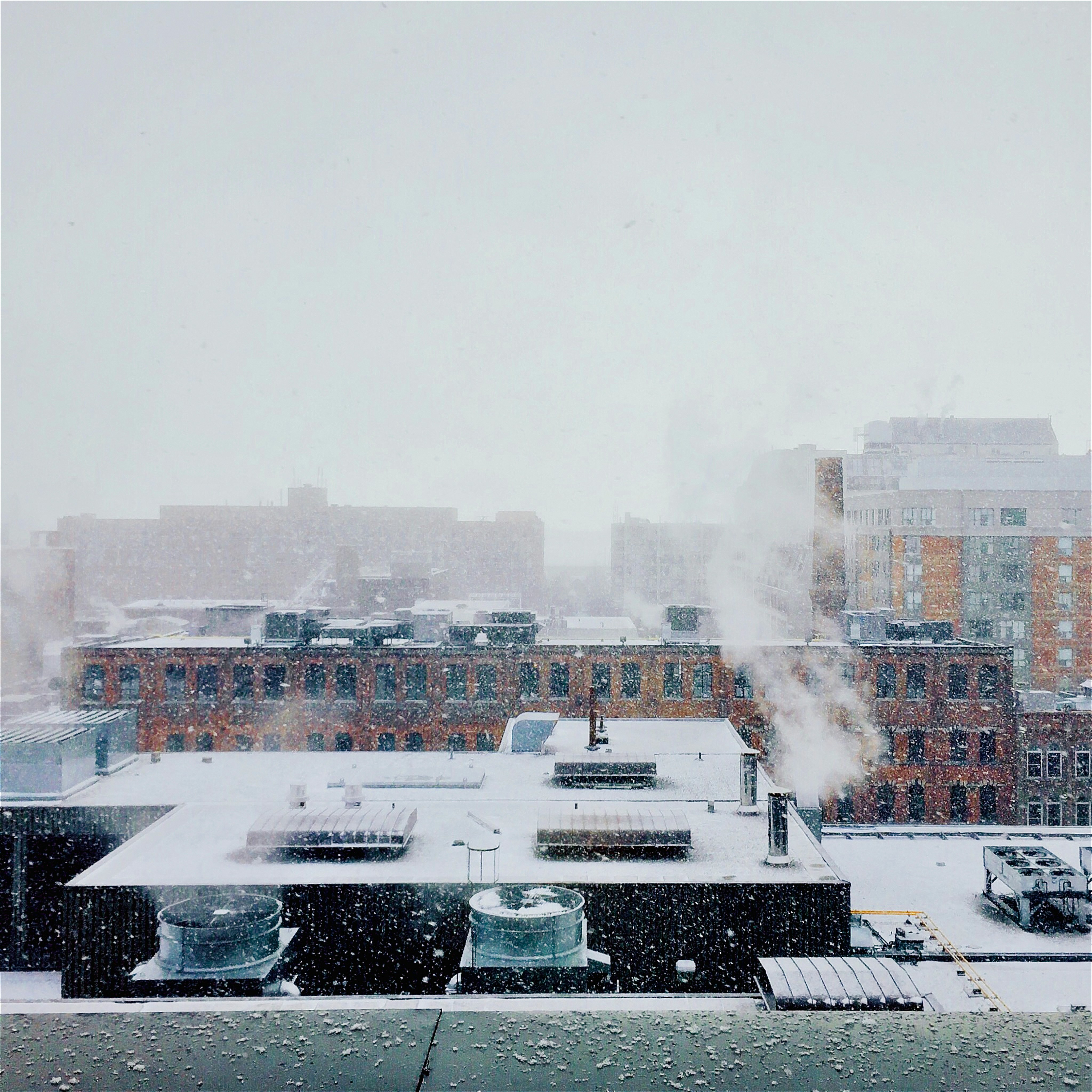 Snowy city skyline with industrial steam - Free Photo on Unsplash