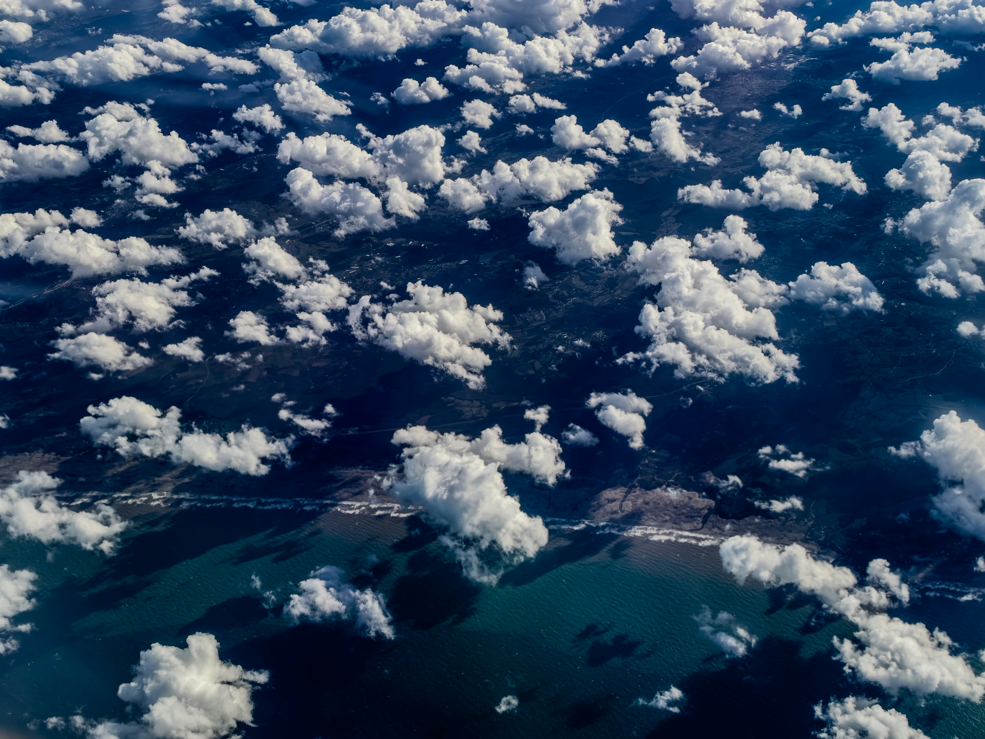 Aerial view of coastline and clouds - Free Photo on Unsplash