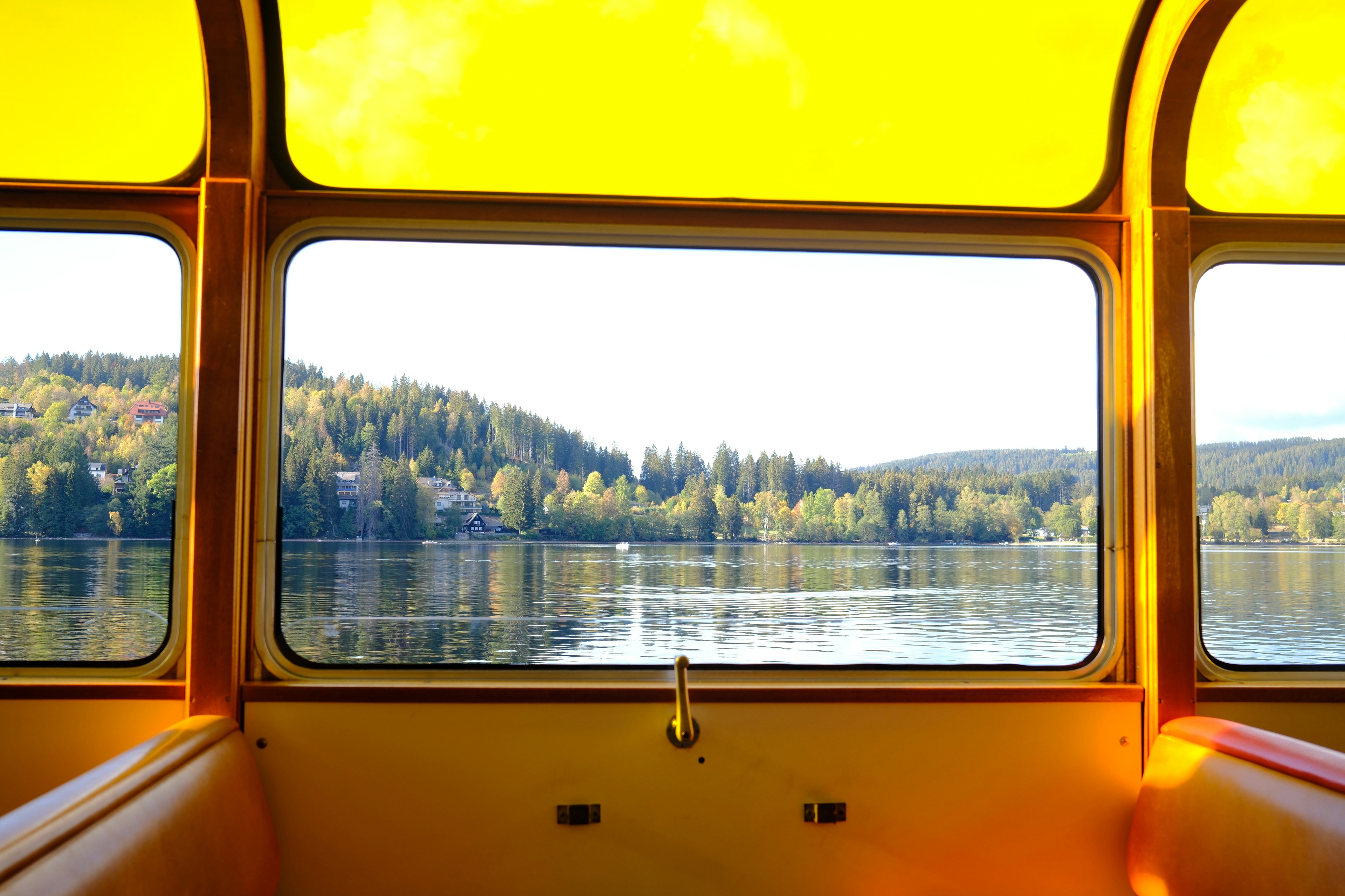 Lake view through yellow boat windows - Free Photo on Unsplash