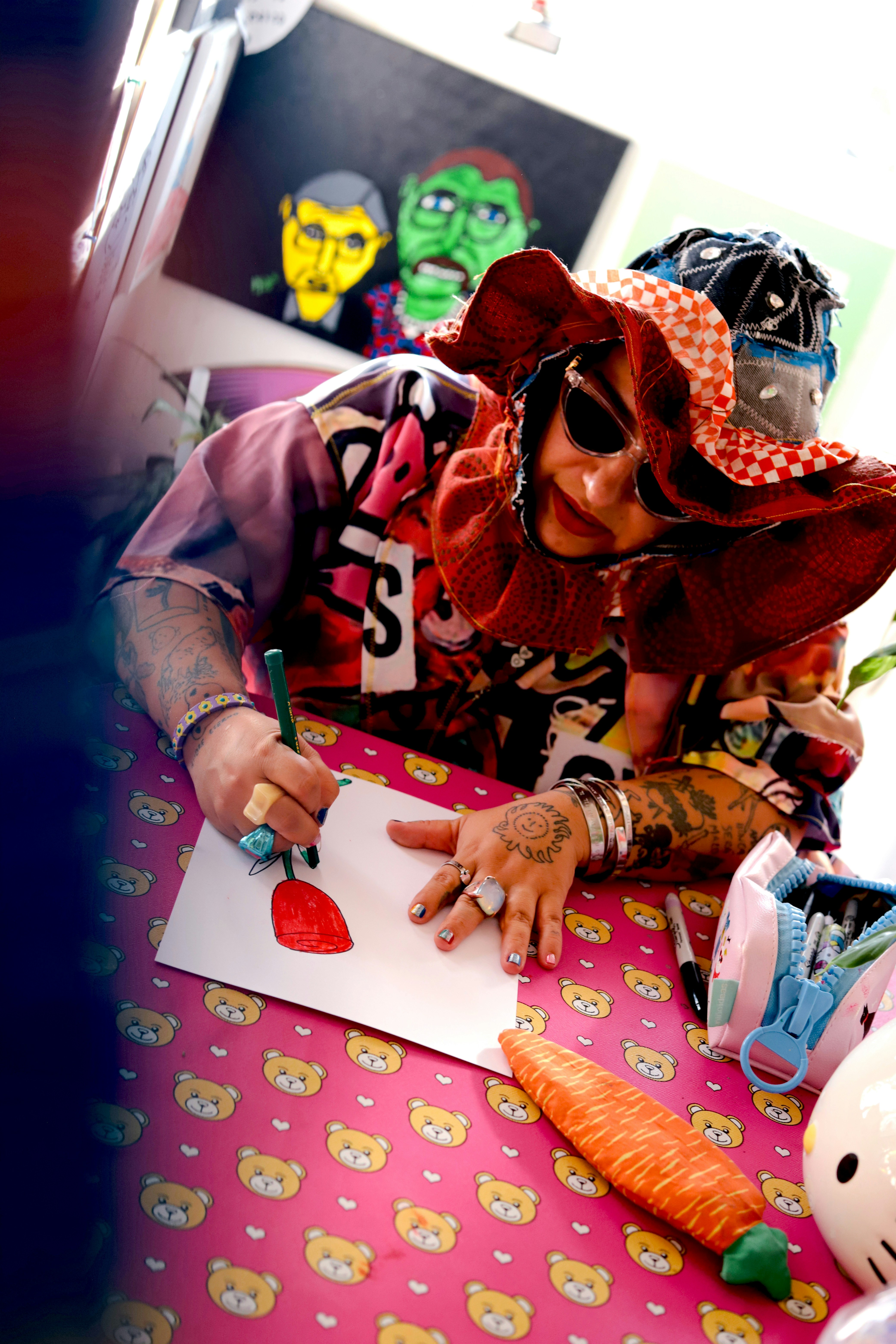 Person drawing flower at patterned table - Free Photo on Unsplash