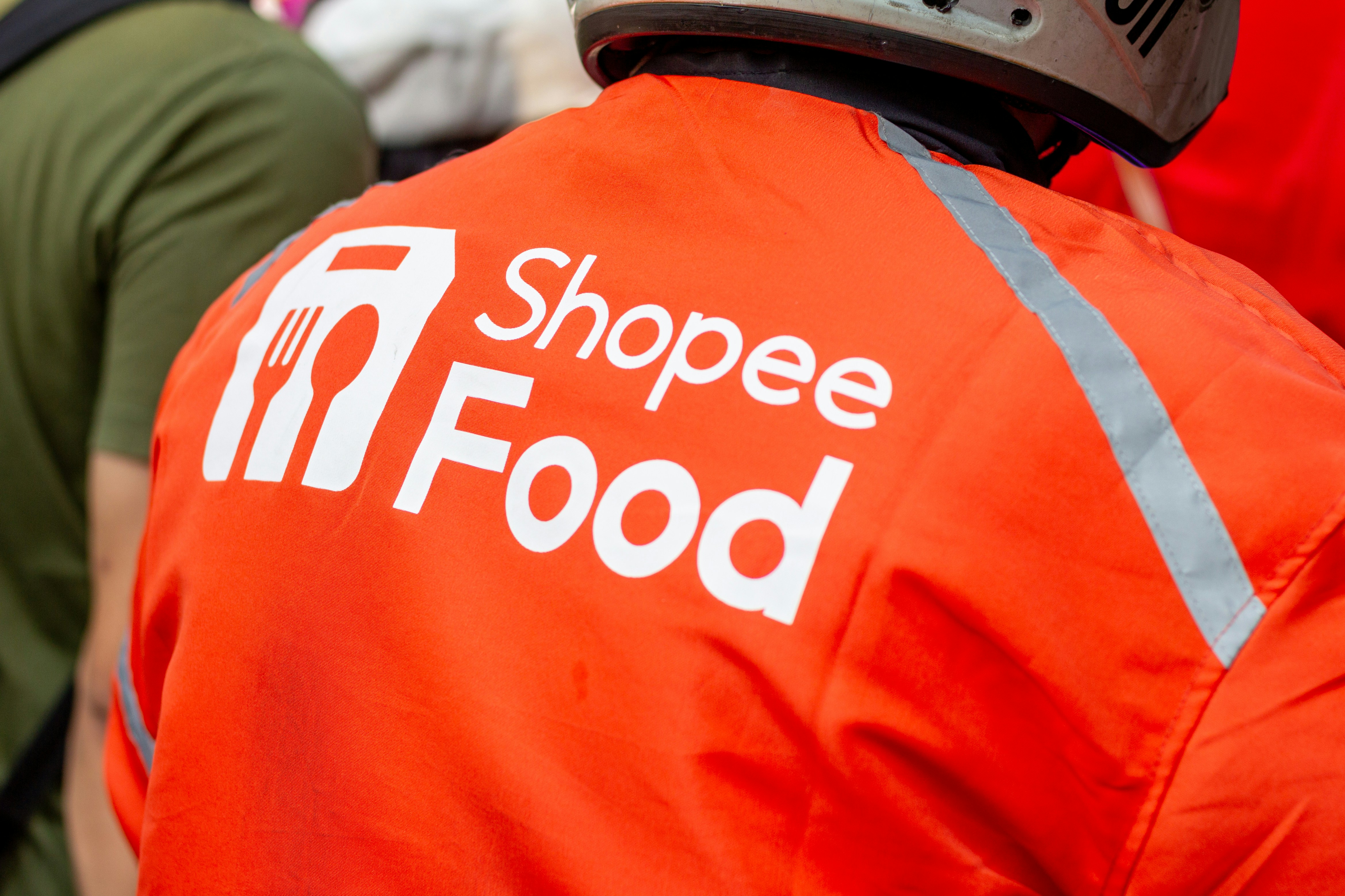 Person wearing orange Shopee Food jacket - Free Photo on Unsplash
