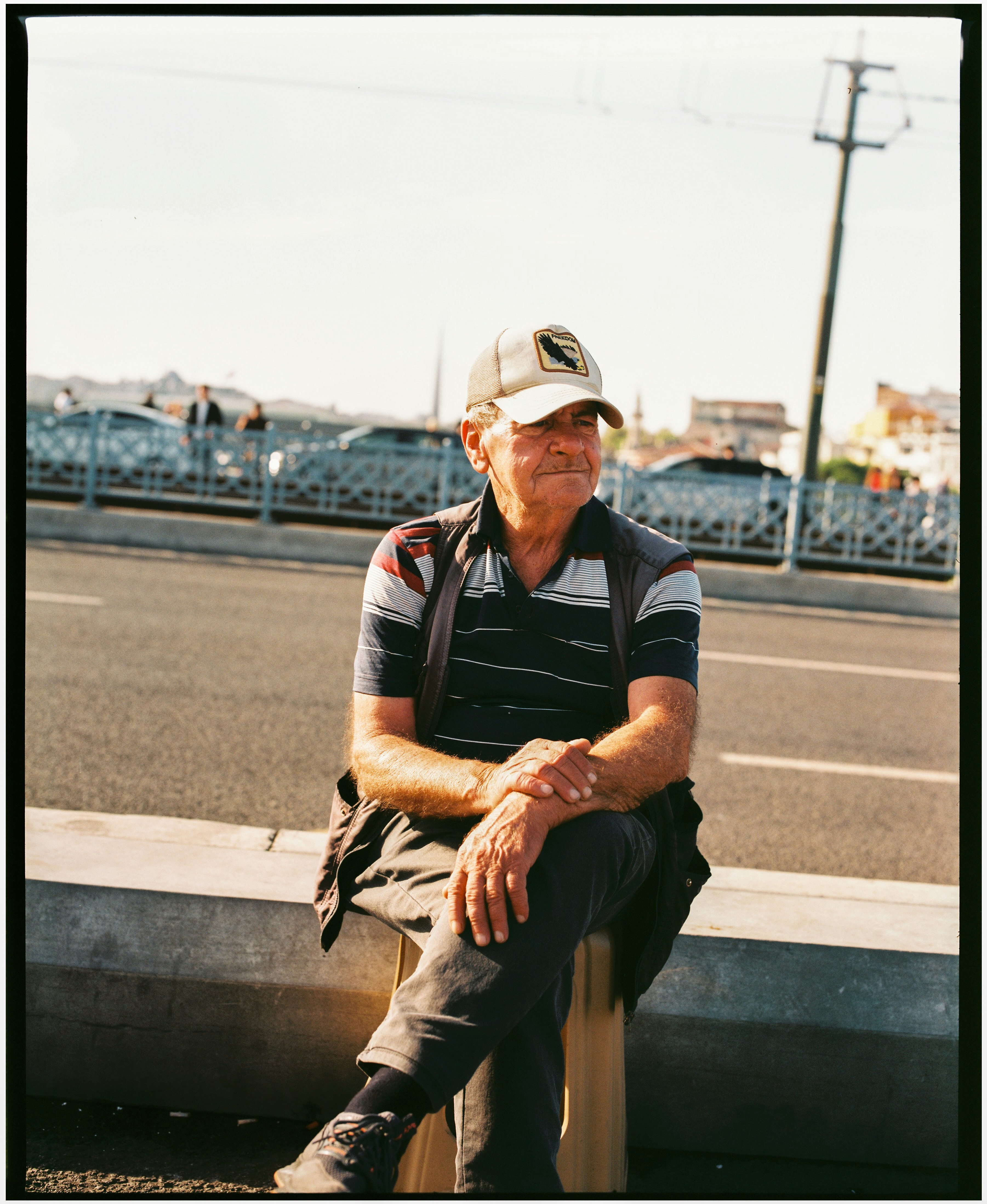 Older man sitting on city bridge - Free Photo on Unsplash