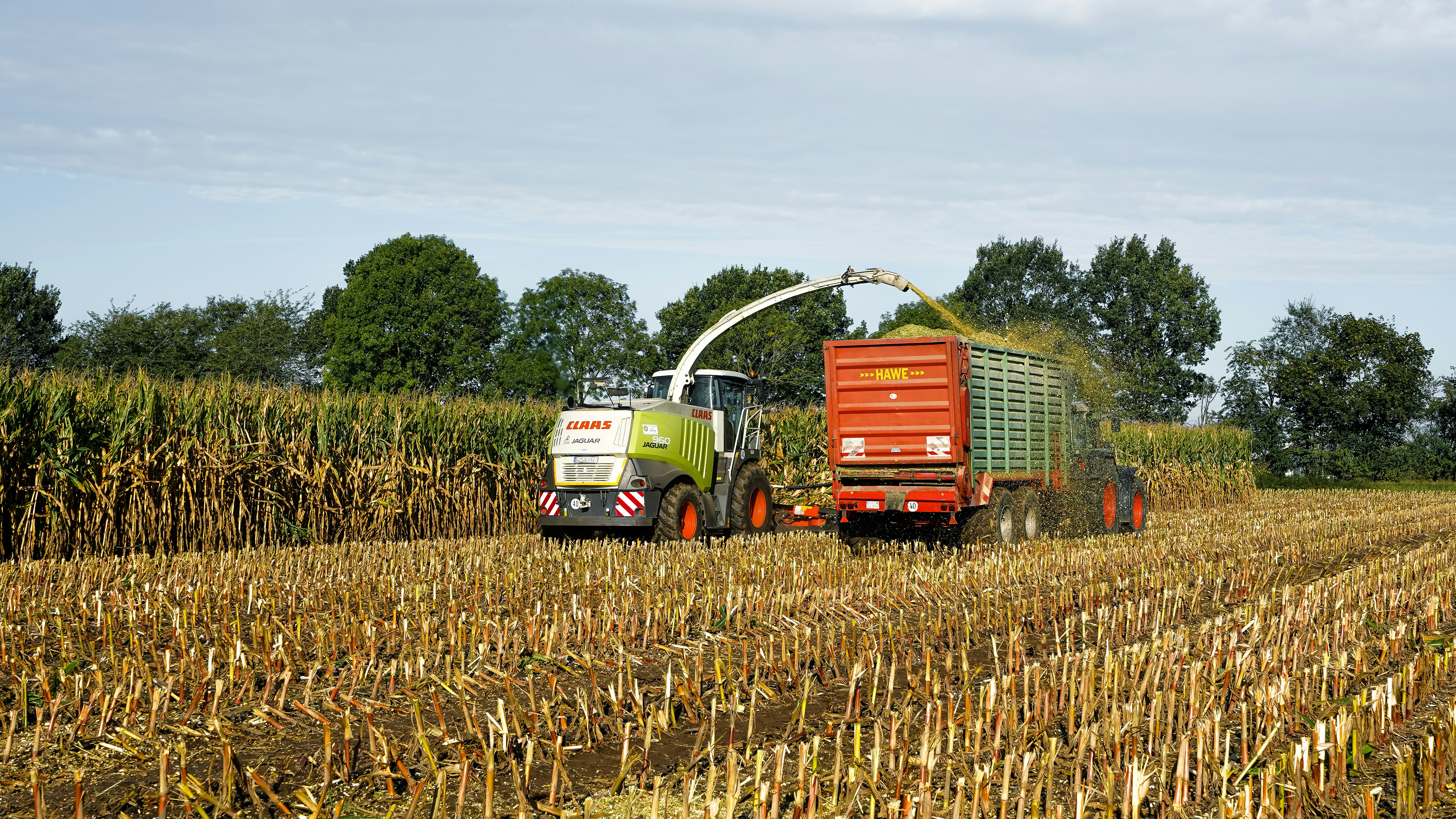 Forage harvester filling trailer with corn - Free Photo on Unsplash