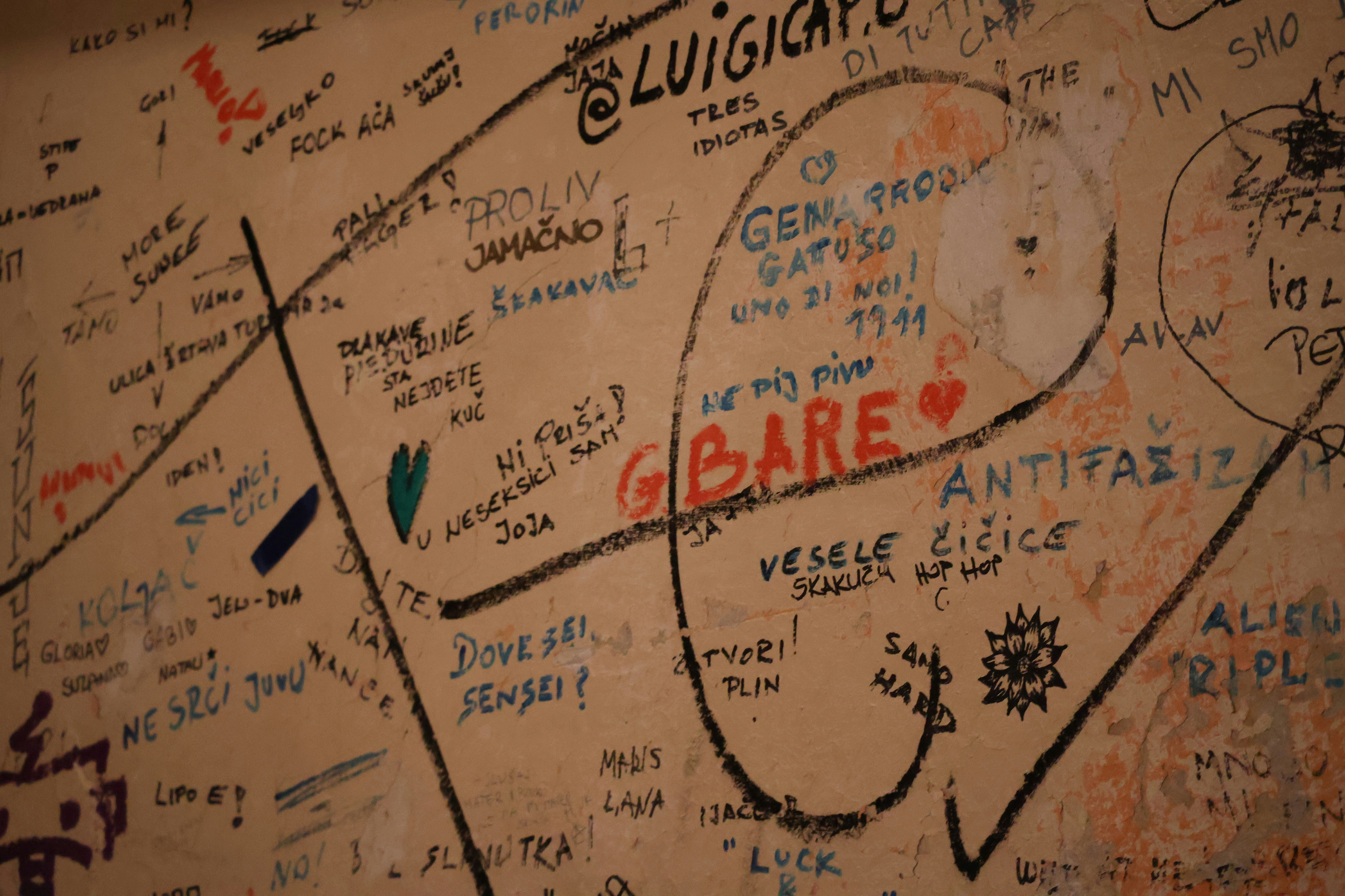Beige wall with handwritten graffiti - Free Photo on Unsplash