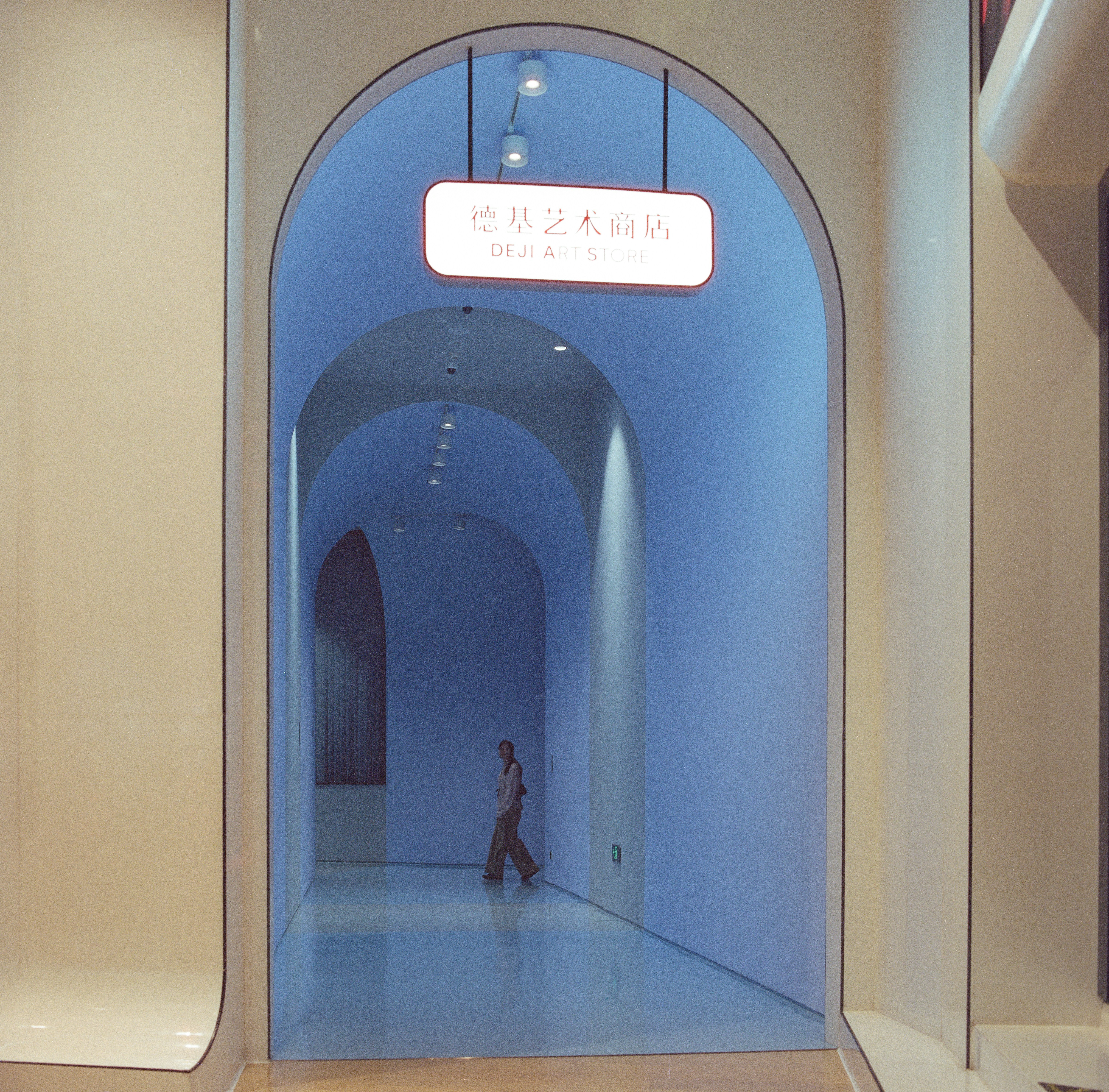 Person walking through blue arched corridor - Free Photo on Unsplash
