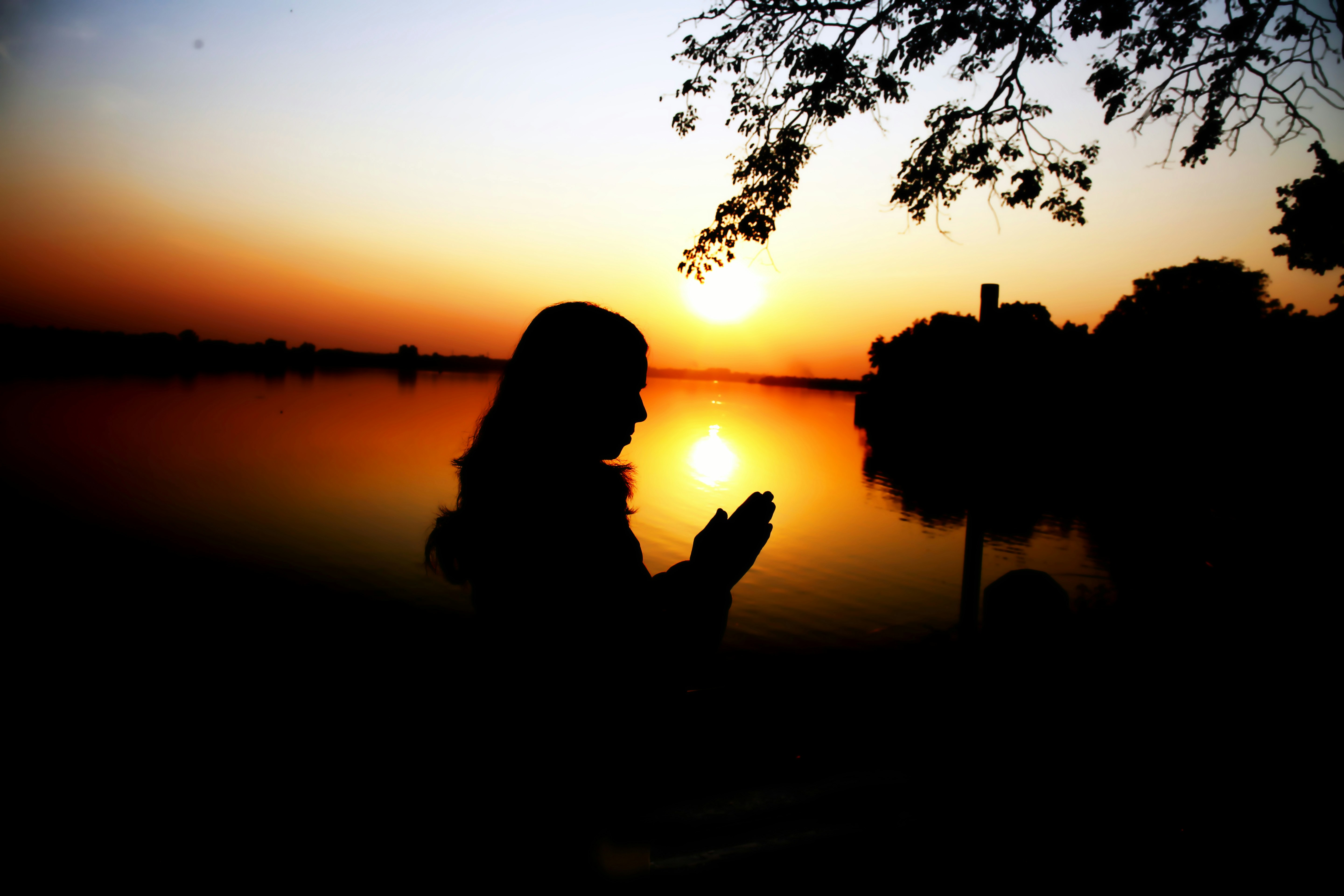 Person in silhouette against reflective water - Free Photo on Unsplash