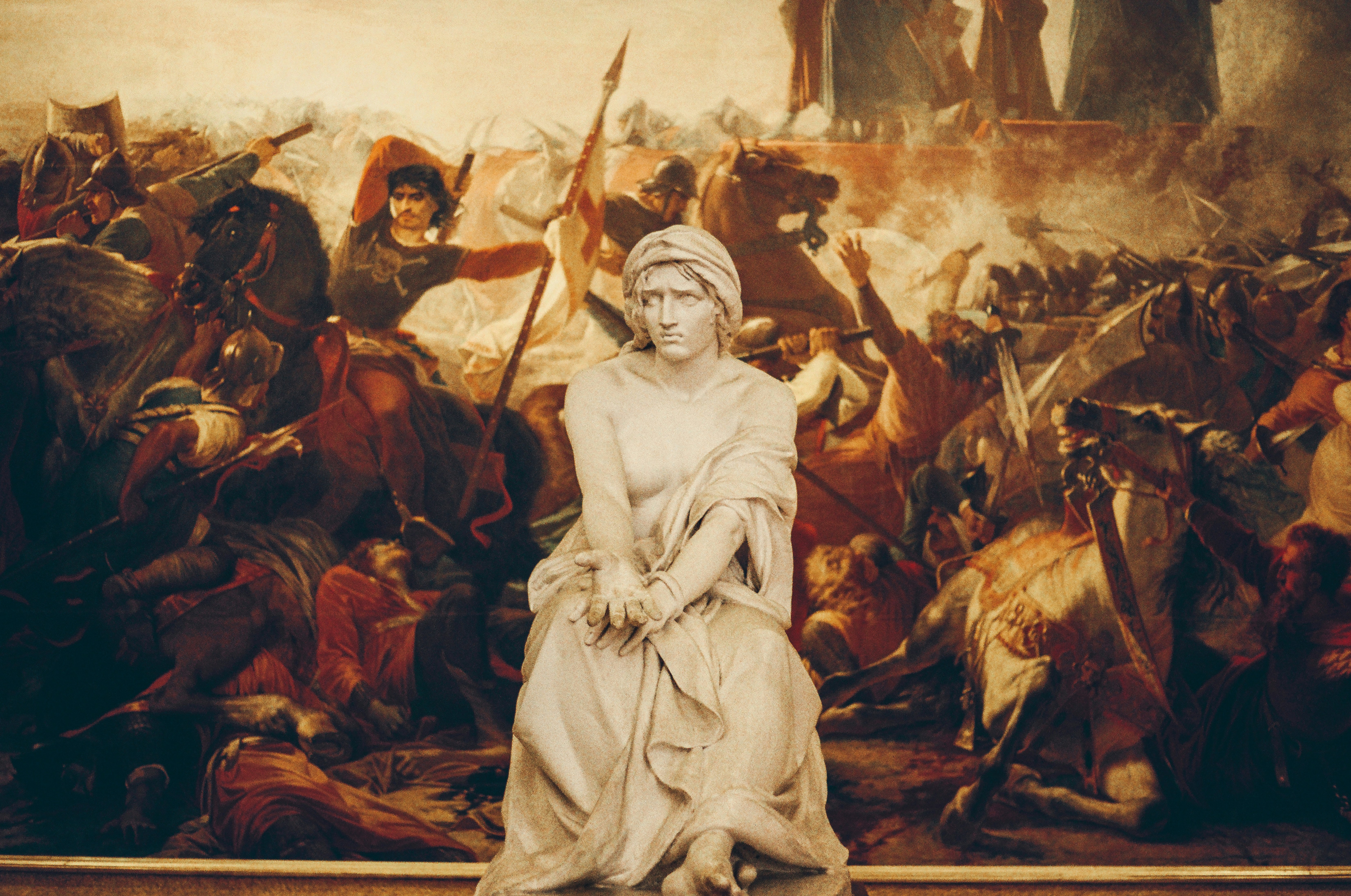 Stone sculpture before battle painting - Free Photo on Unsplash