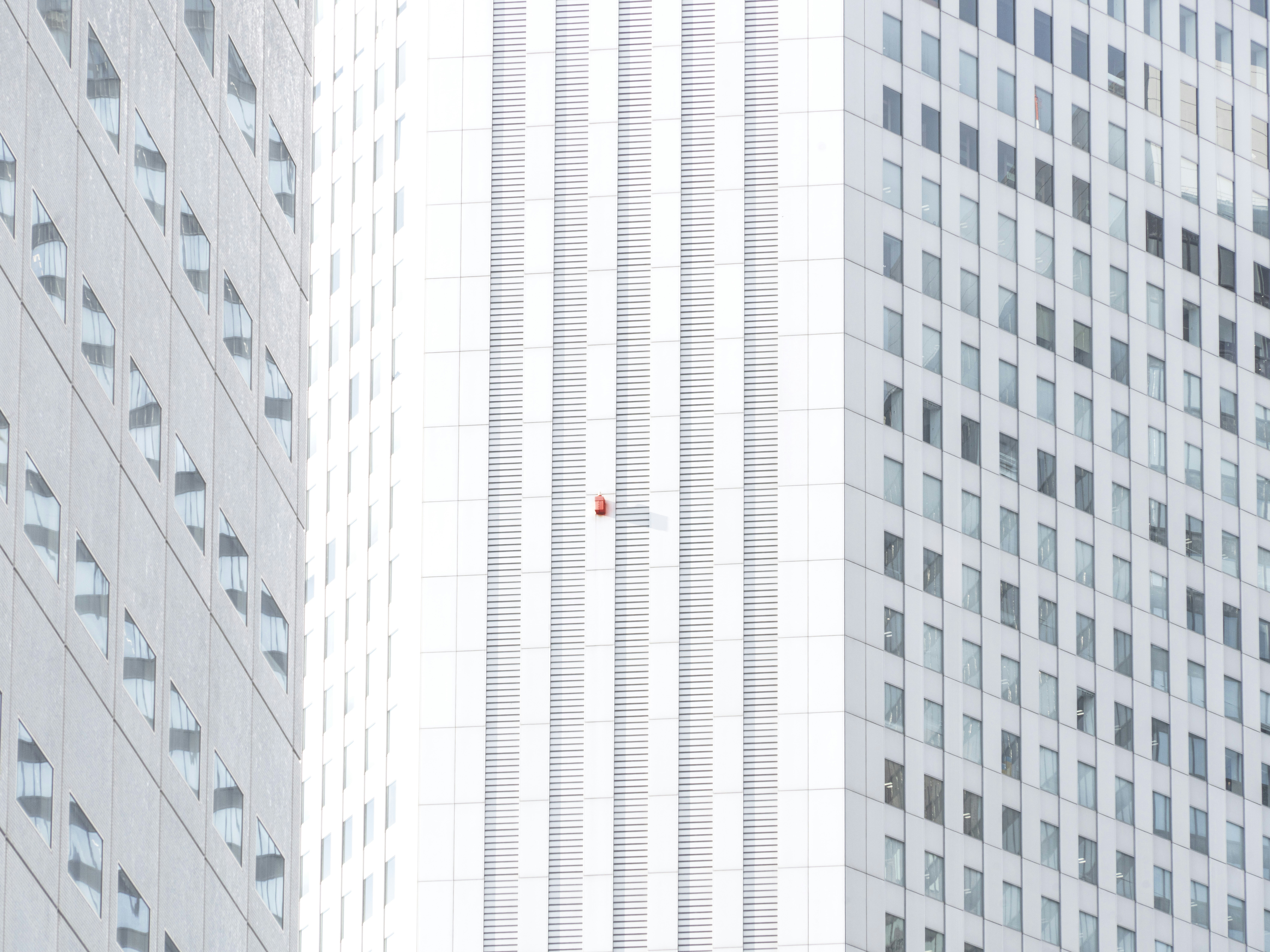 Red object on white office building - Free Photo on Unsplash