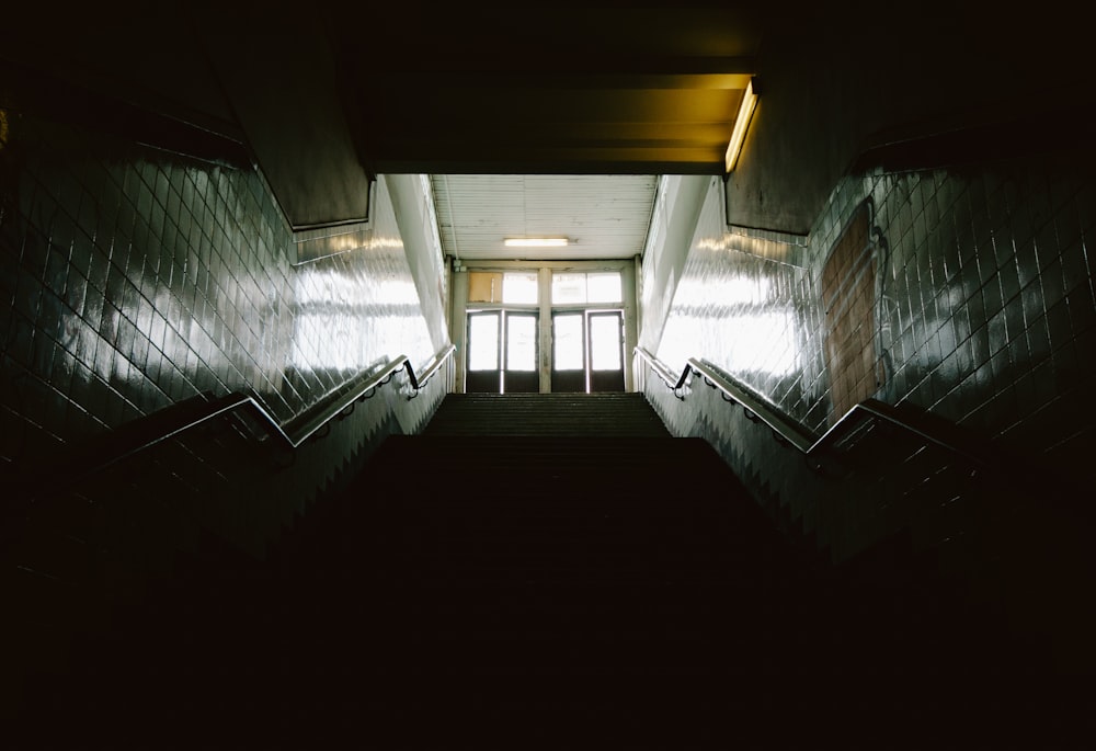 long angle photography of dark staircase