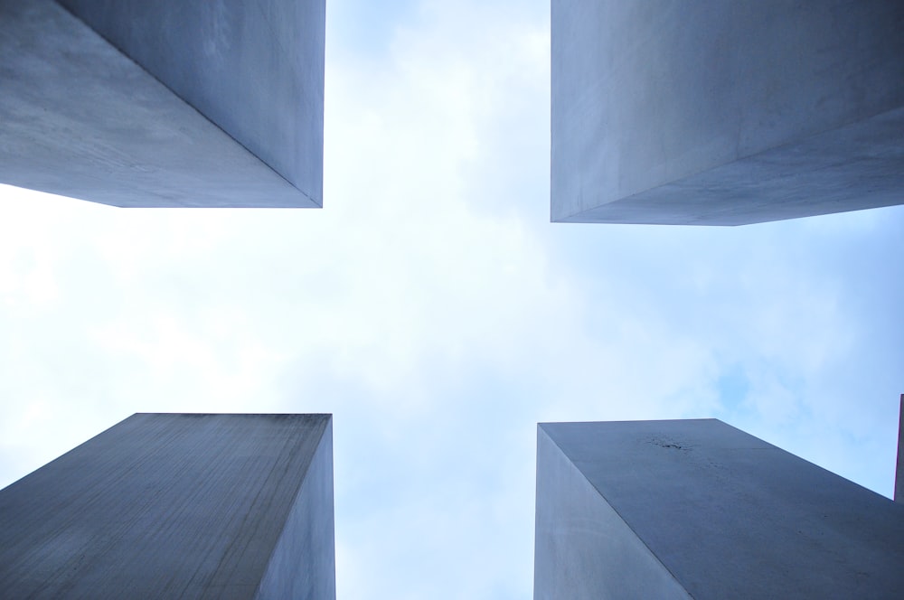 worm's eye view of four stone structures during daytime