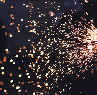 Macro image of tiny electric sparks spinning off from a metal electrode.