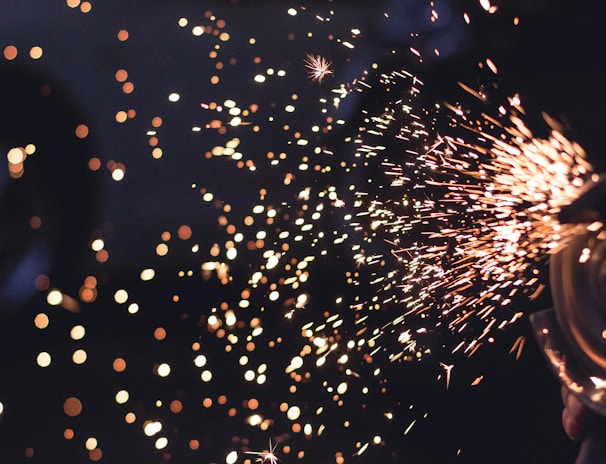 Macro image of tiny electric sparks spinning off from a metal electrode.