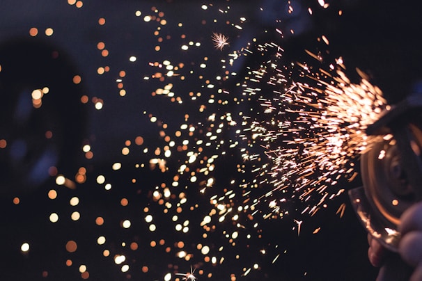 Macro image of tiny electric sparks spinning off from a metal electrode.