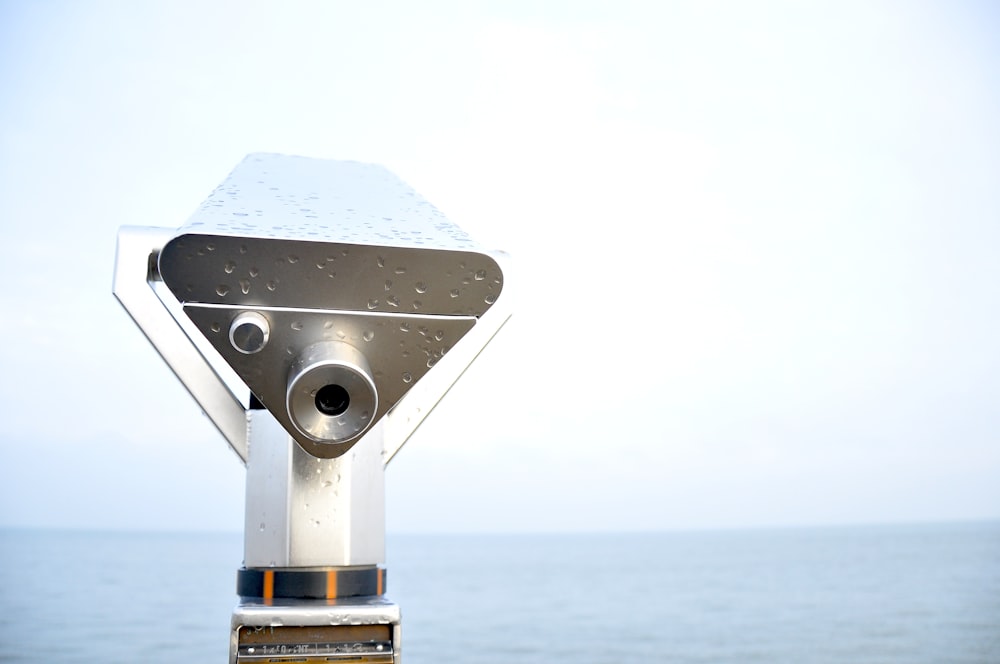 silver telescope with rain drops