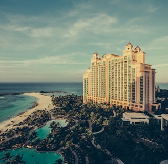 yellow concrete building beside body of water