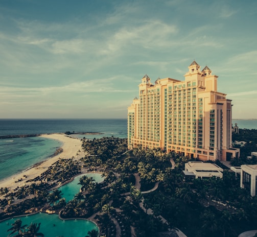 yellow concrete building beside body of water