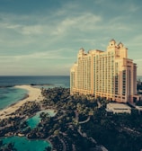yellow concrete building beside body of water