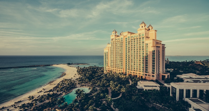 yellow concrete building beside body of water